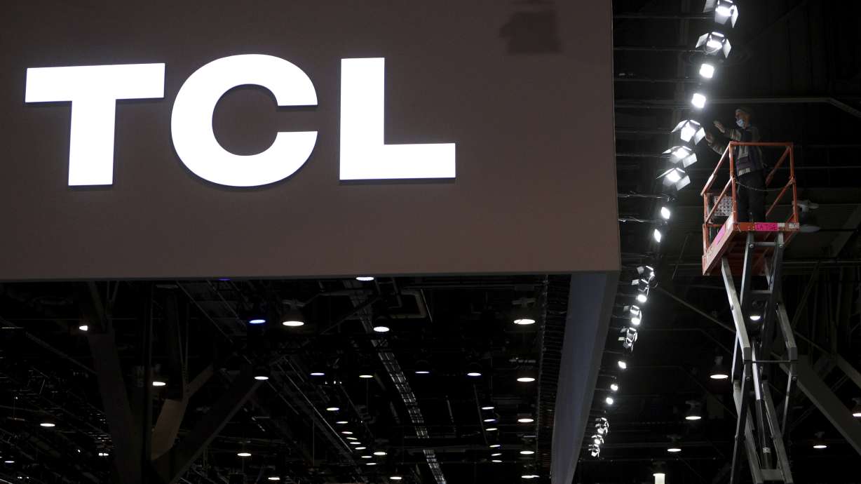 FILE -TCL logo is seen as workers prepare a booth during setup for the CES tech show Jan. 4, 2022, in Las Vegas.