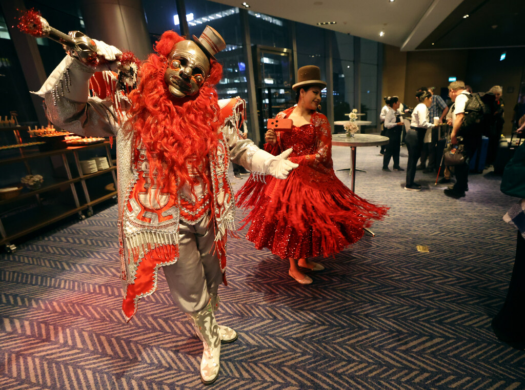 Performers pose and dance as members of The Tabernacle Choir and Orchestra at Temple Square check into The Westin Lima Hotel and Convention Center in Lima, Peru, for the “Songs of Hope” world tour on Tuesday.