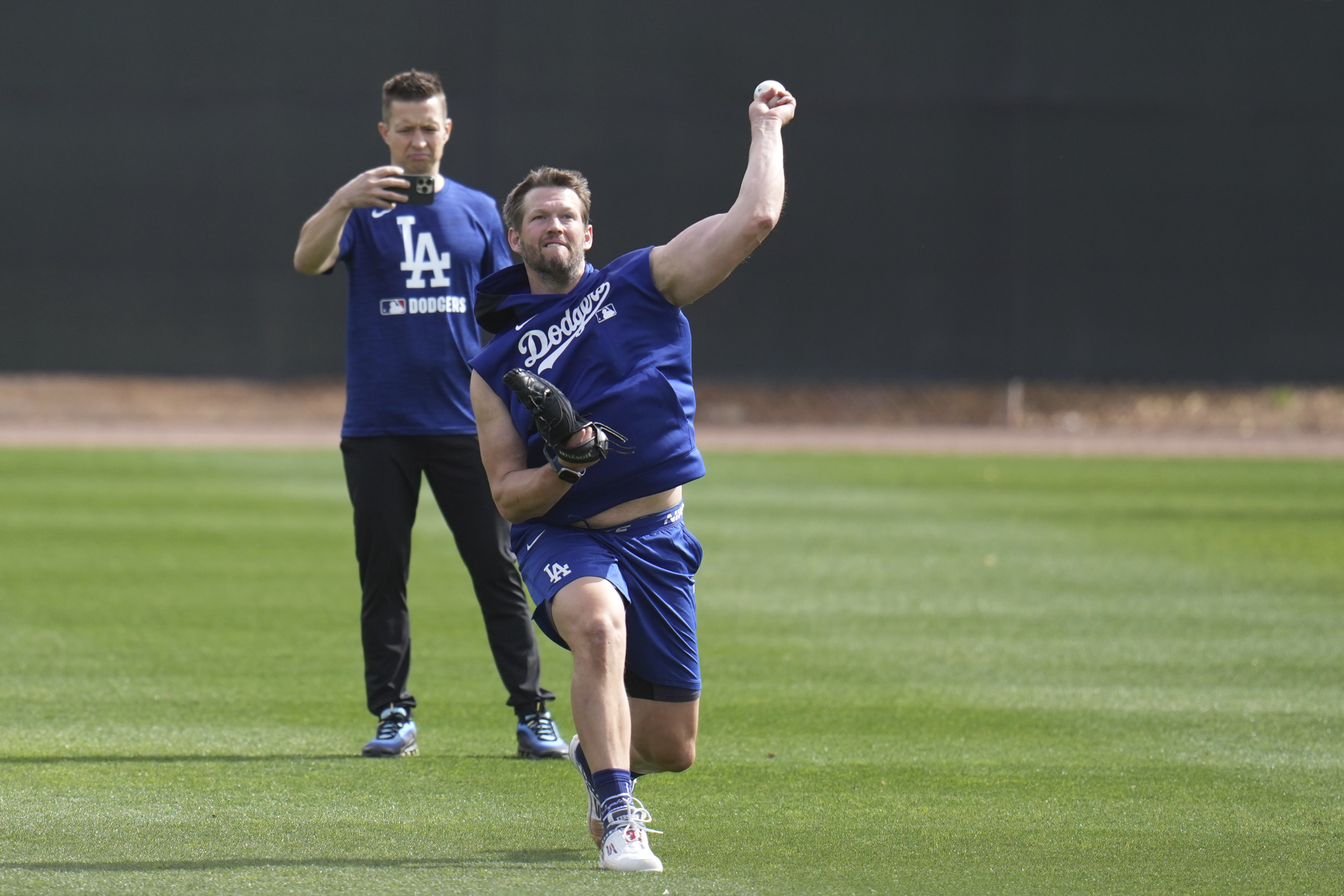 Los Angeles Dodgers pitcher Clayton Kershaw warms up at the Dodgers baseball spring training facility, Tuesday, Feb. 11, 2025, in Phoenix.