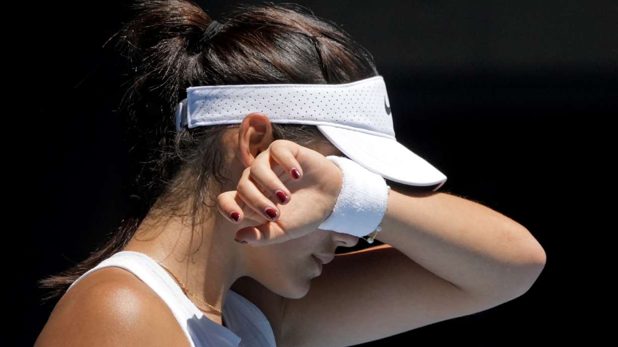 FILE - Emma Raducanu of Britain reacts during her third round match Iga Swiatek of Poland during their third round match at the Australian Open tennis championship in Melbourne, Australia, Saturday, Jan. 18, 2025.