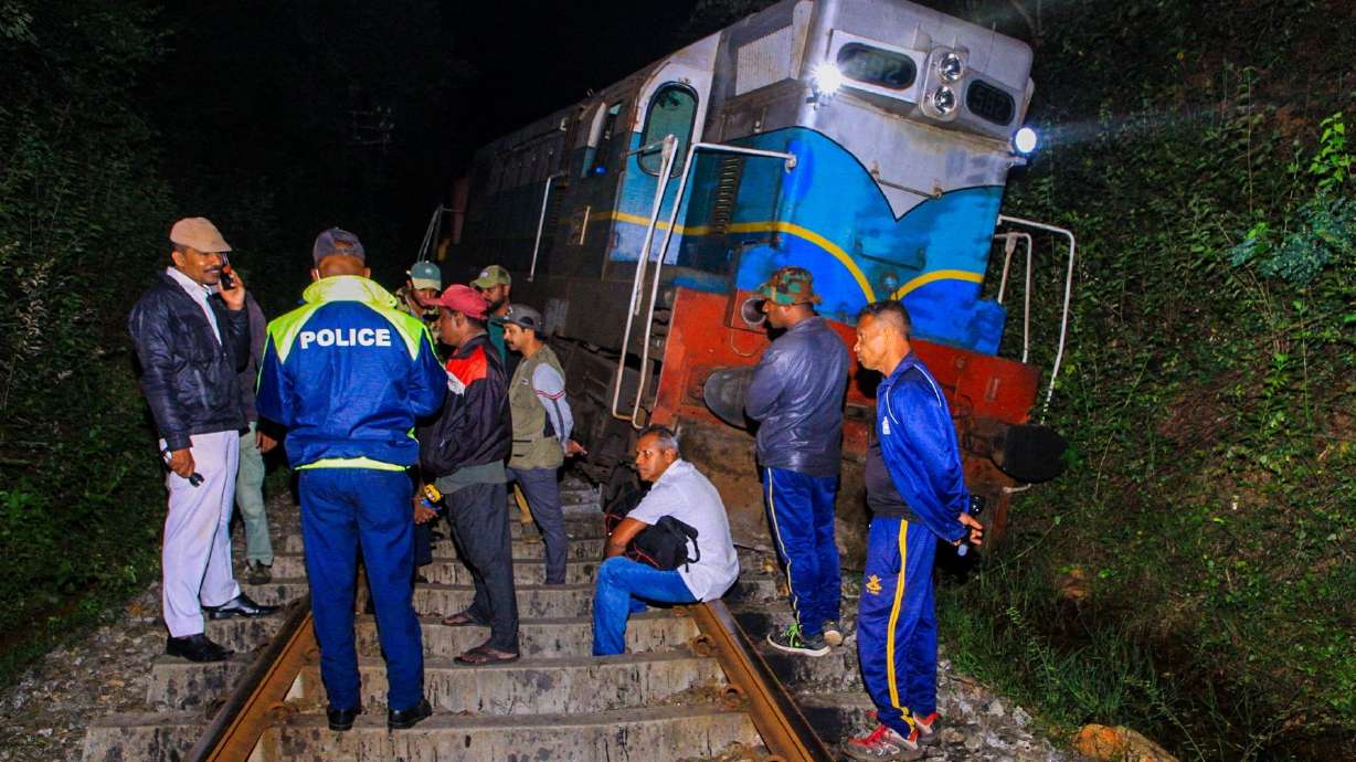 Police and railway personnel examine a derailed train at Habarana in eastern Sri Lanka on Thursday, which killed six elephants.