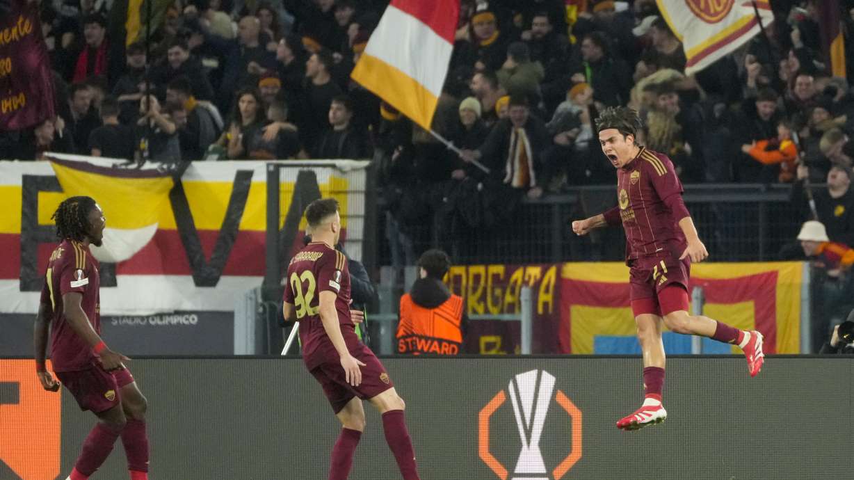Roma's Paulo Dybala, right, celebrates with teammates after scoring his side's opening goal during the Europa League playoff second leg soccer match between Roma and Porto at the Stadio Olimpico in Rome, Italy, Thursday, Feb. 20, 2025.