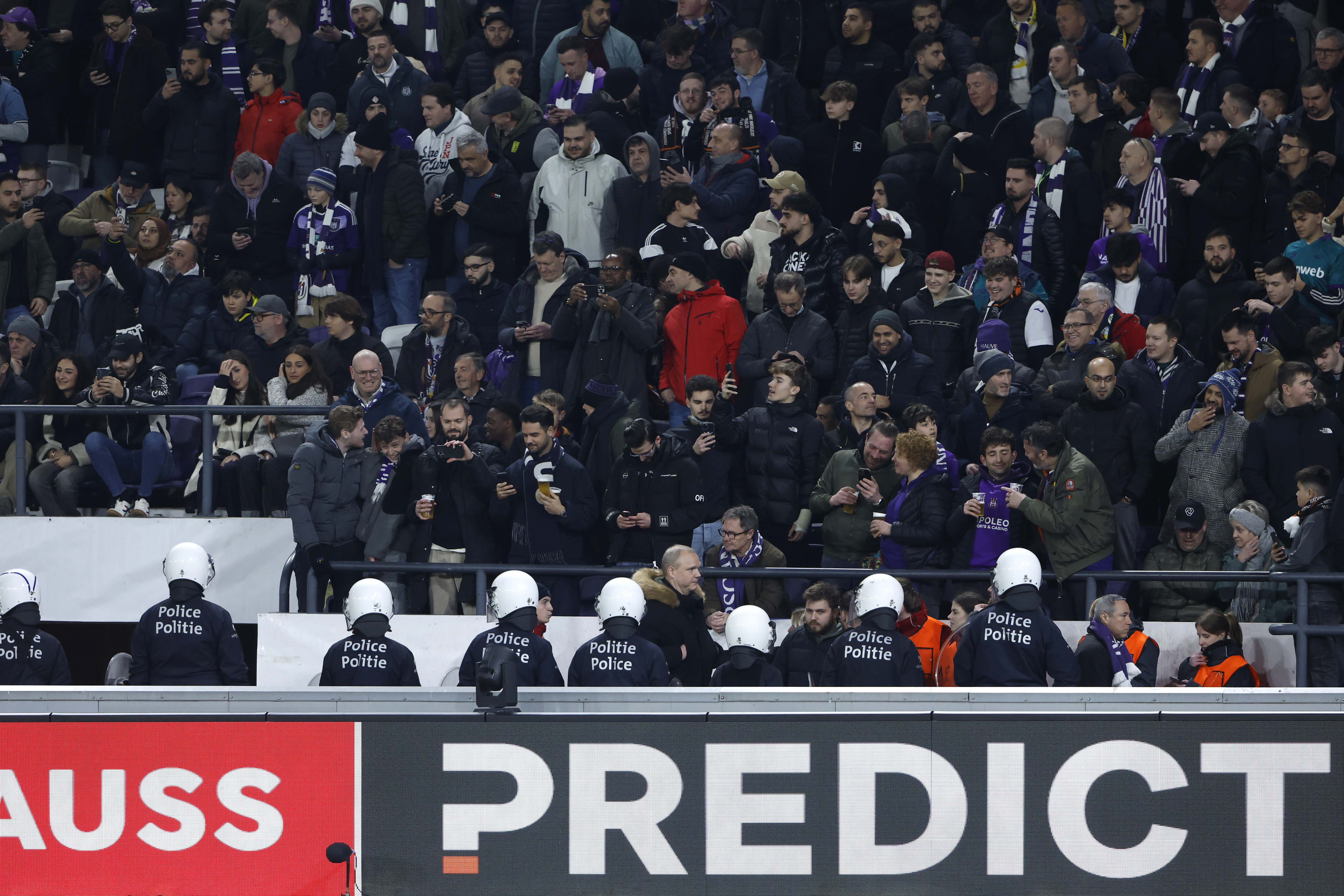 Riot police are deployed after an incident with supporters during the Europa League playoff second leg soccer match between Anderlecht and Fenerbahce at the RSC Anderlecht stadium in Brussels, Thursday, Feb. 20, 2025. 