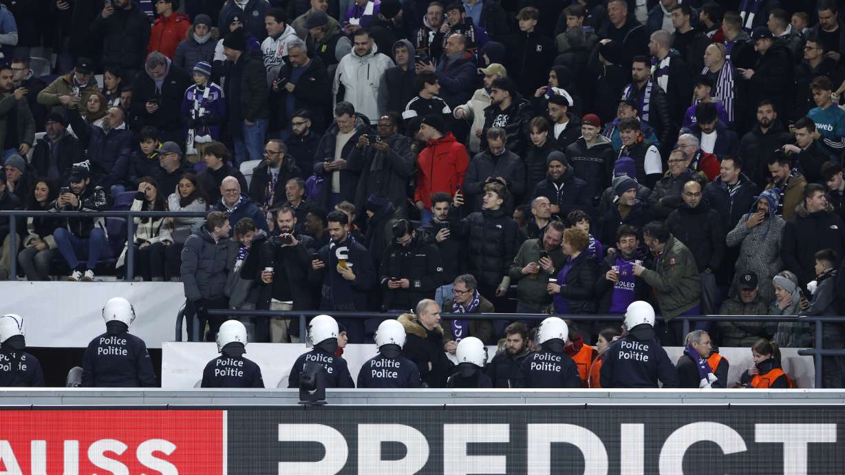 Riot police are deployed after an incident with supporters during the Europa League playoff second leg soccer match between Anderlecht and Fenerbahce at the RSC Anderlecht stadium in Brussels, Thursday, Feb. 20, 2025.