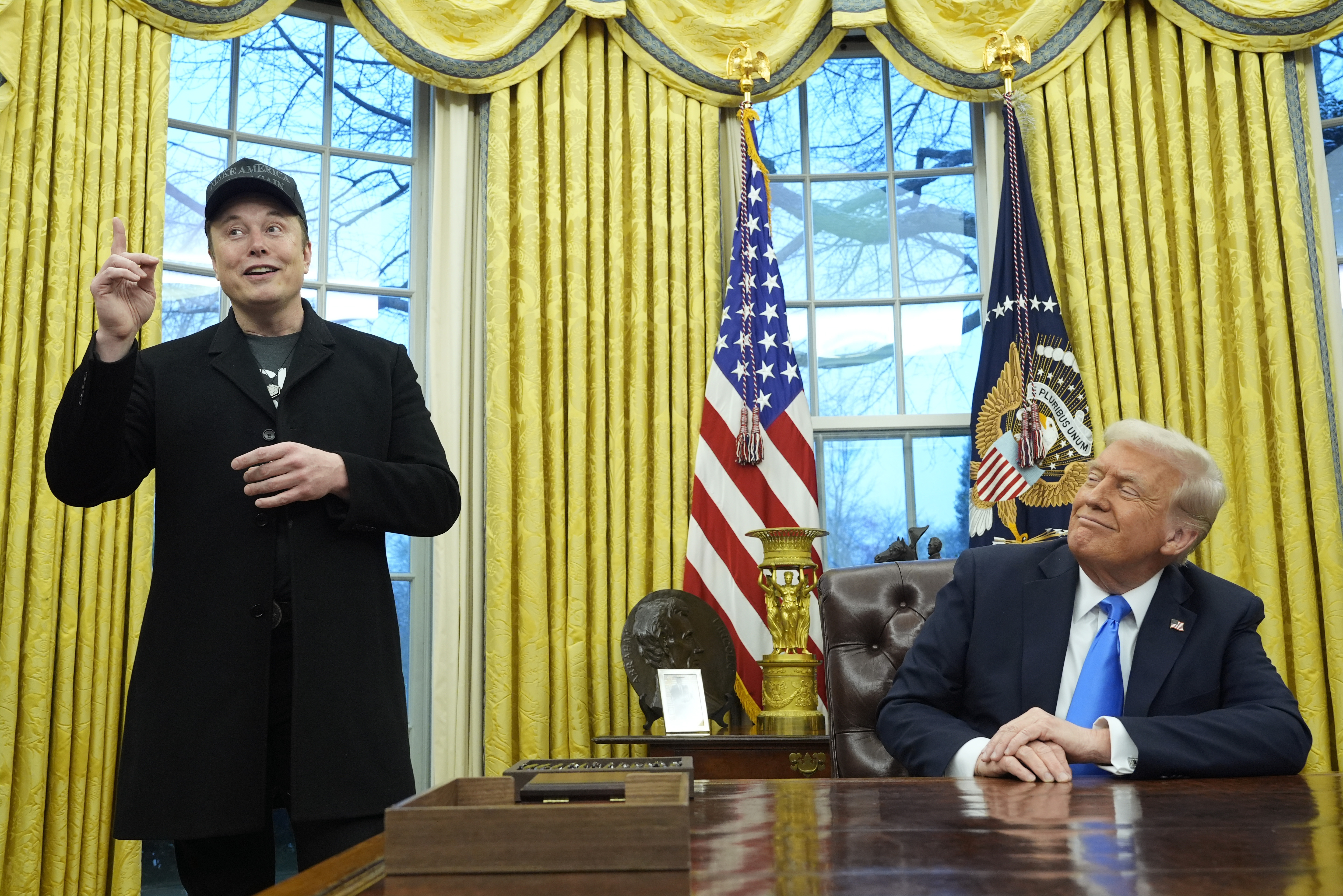 President Donald Trump listens as Elon Musk speaks in the Oval Office at the White House, Feb. 11, in Washington.