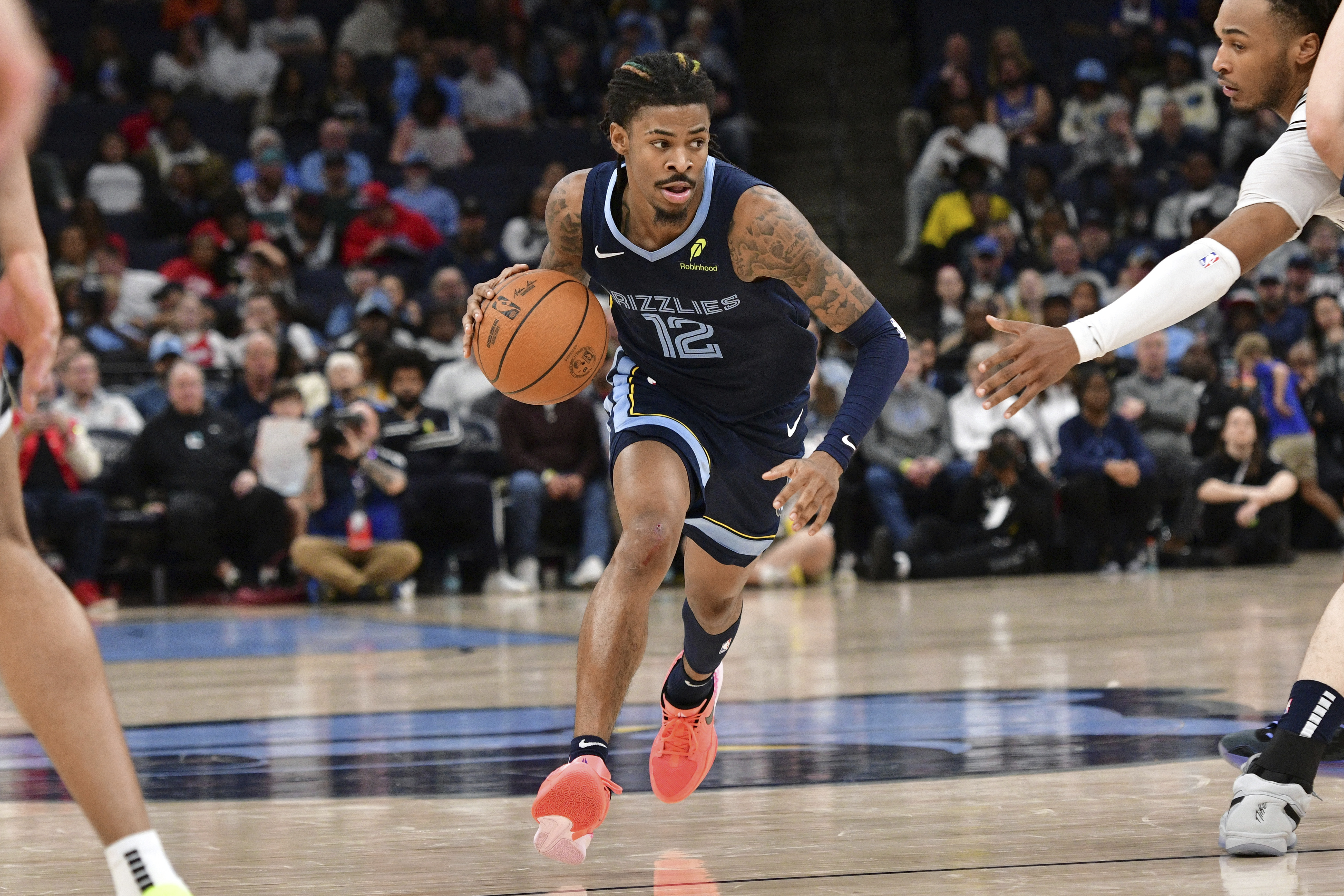 Memphis Grizzlies guard Ja Morant (12) handles the ball against the San Antonio Spurs in the second half of an NBA basketball game Monday, Feb. 3, 2025, in Memphis, Tenn.