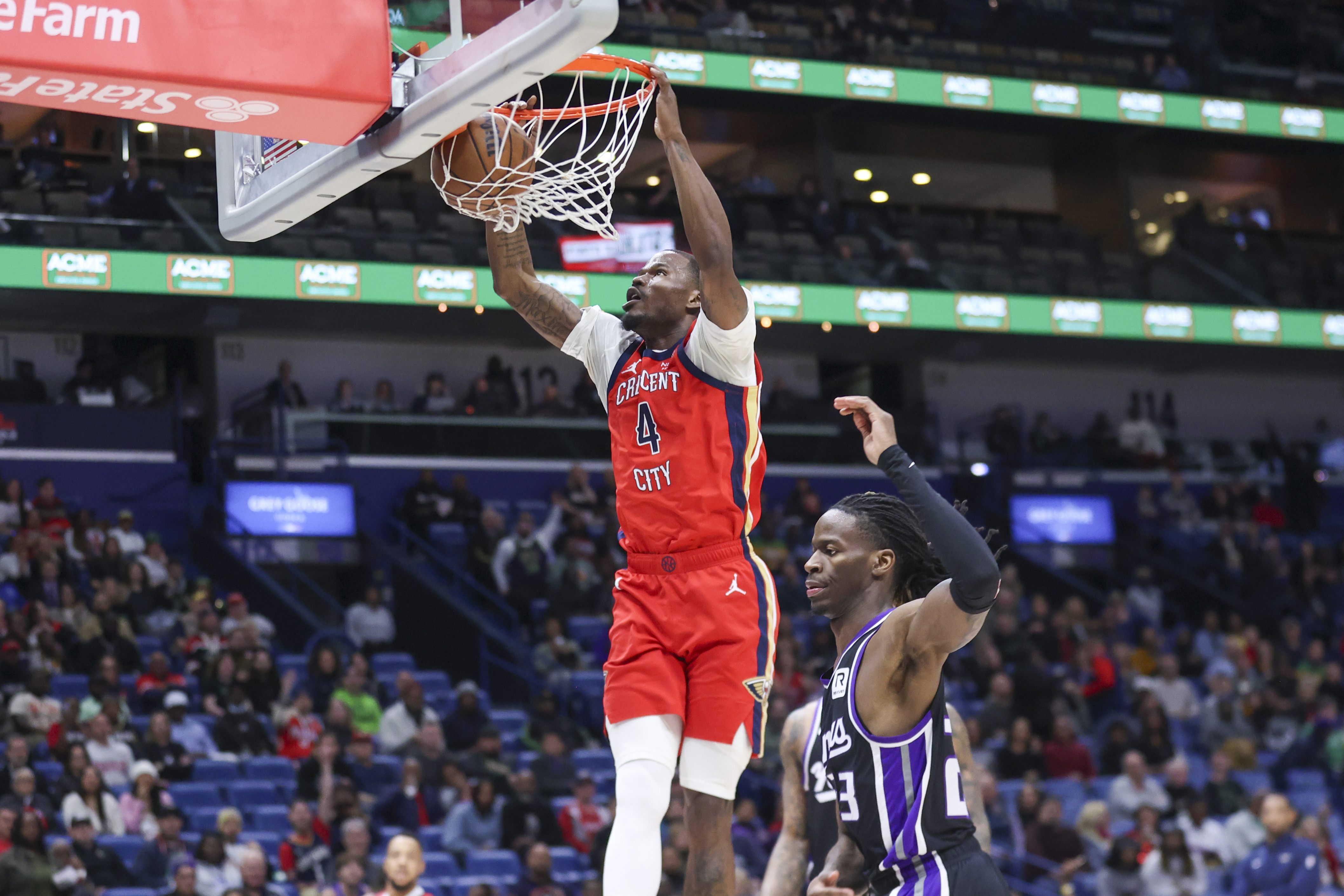 New Orleans Pelicans guard Javonte Green (4) throws down a fast break dunk against Sacramento Kings guard Keon Ellis (23) during the first half of an NBA basketball game in New Orleans, Thursday, Feb. 13, 2025. 