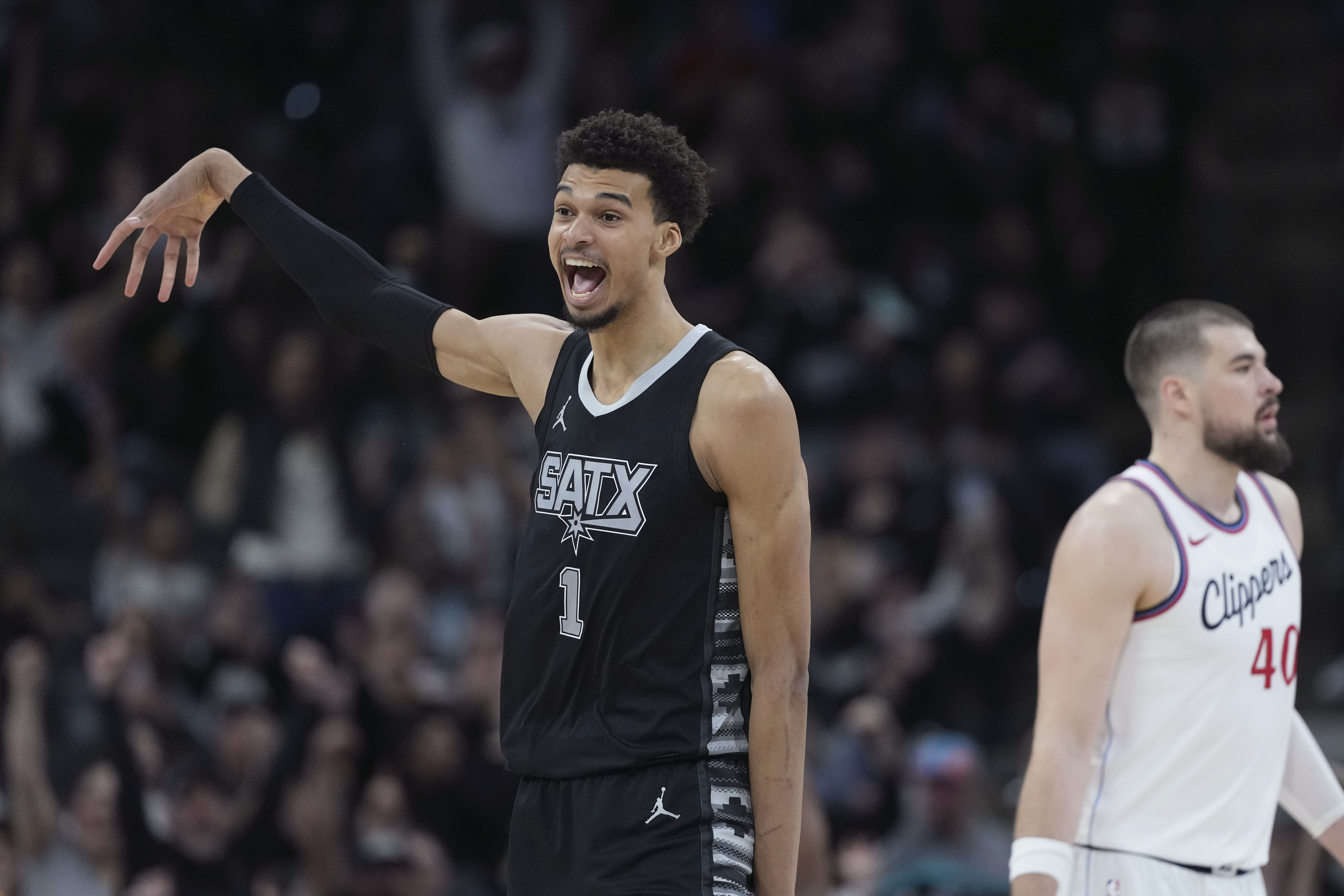 San Antonio Spurs center Victor Wembanyama (1) reacts to a score against the LA Clippers during the second half of an NBA basketball game in San Antonio, Wednesday, Jan. 29, 2025. 