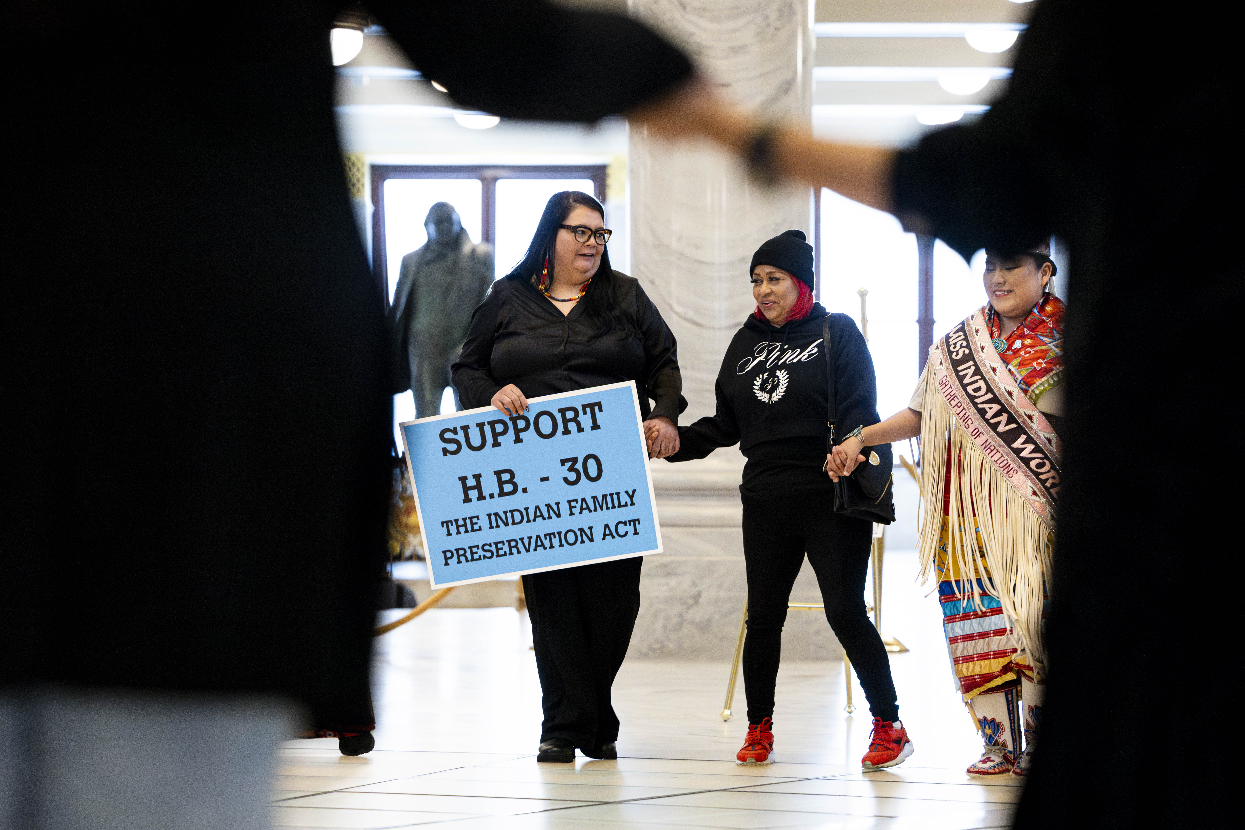 Autumn Gillard, cultural resource manager of the Paiute Indian Tribe of Utah, holds a sign during a rally supporting the Indian Family Preservation Act, also known as HB30, in the rotunda of the Capitol in Salt Lake City on Thursday.