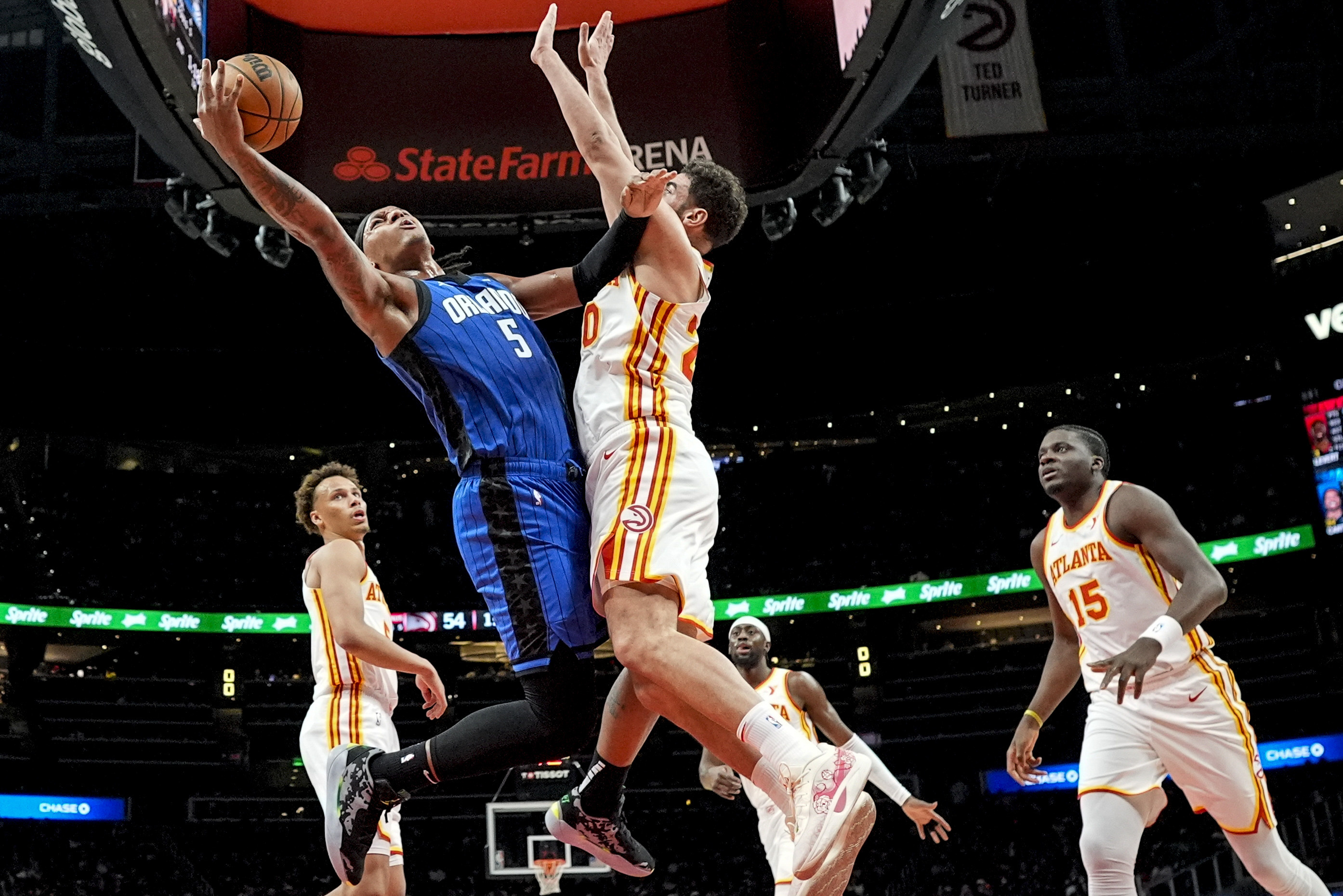 Orlando Magic forward Paolo Banchero (5) shoots against Atlanta Hawks forward Georges Niang (20) during the first half of an NBA basketball game, Thursday, Feb. 20, 2025, in Atlanta. 