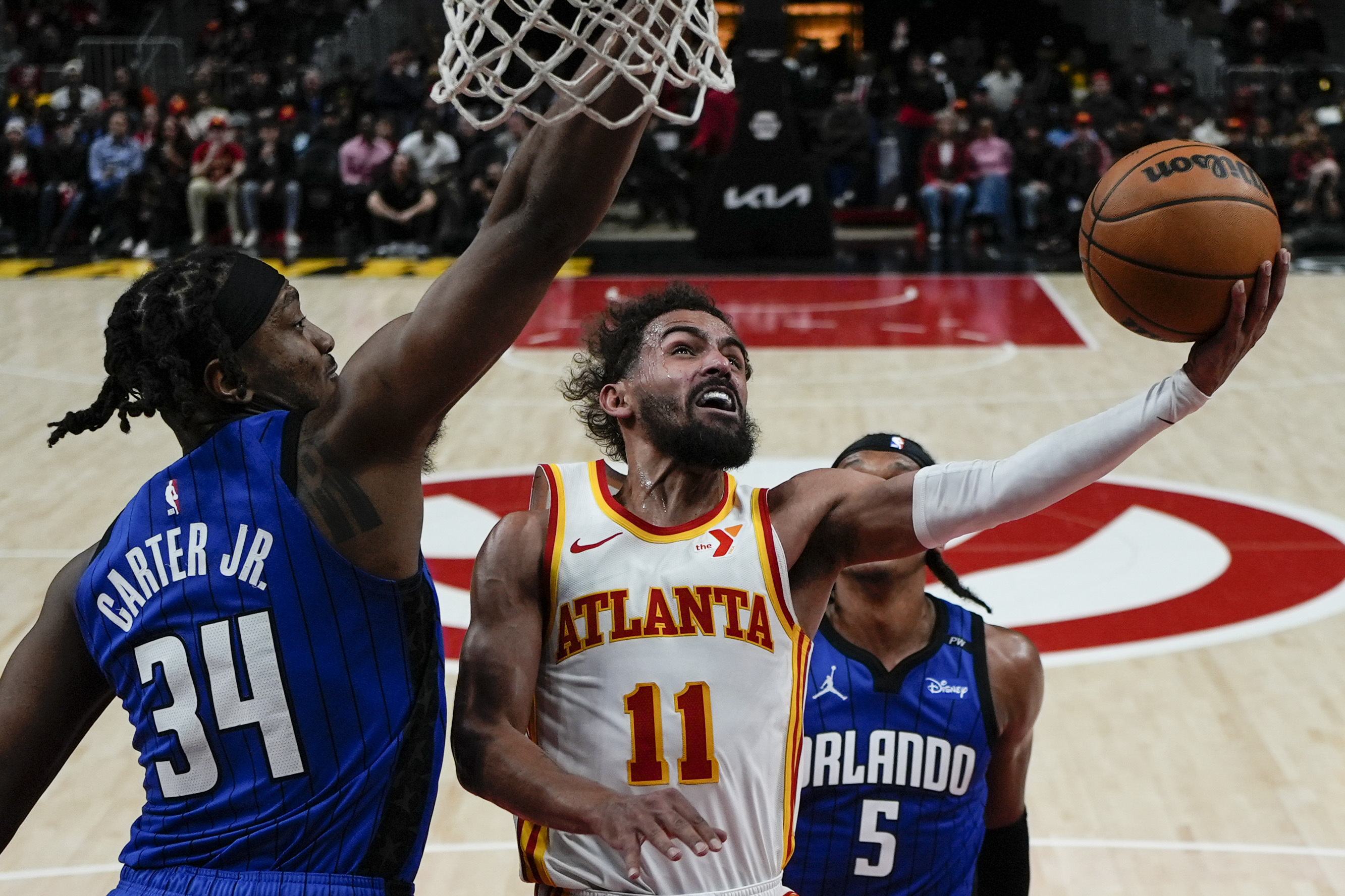 Atlanta Hawks guard Trae Young (11) shoots against Orlando Magic center Wendell Carter Jr. (34) during the second half of an NBA basketball game, Thursday, Feb. 20, 2025, in Atlanta. 