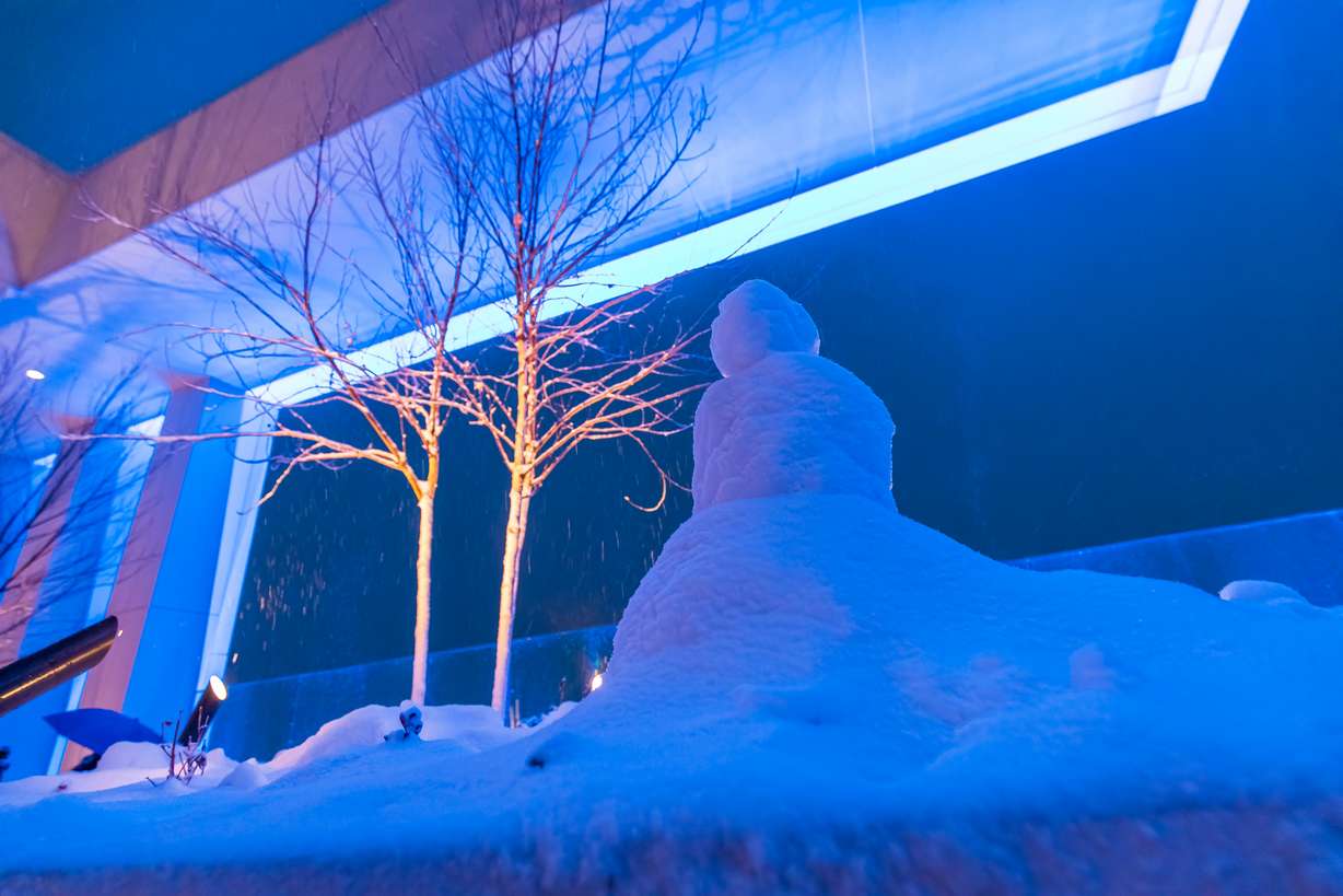 A snowman is illuminated blue atop Astra Tower in Salt Lake City on Thursday. The building's lights serve as an air quality forecast beacon.