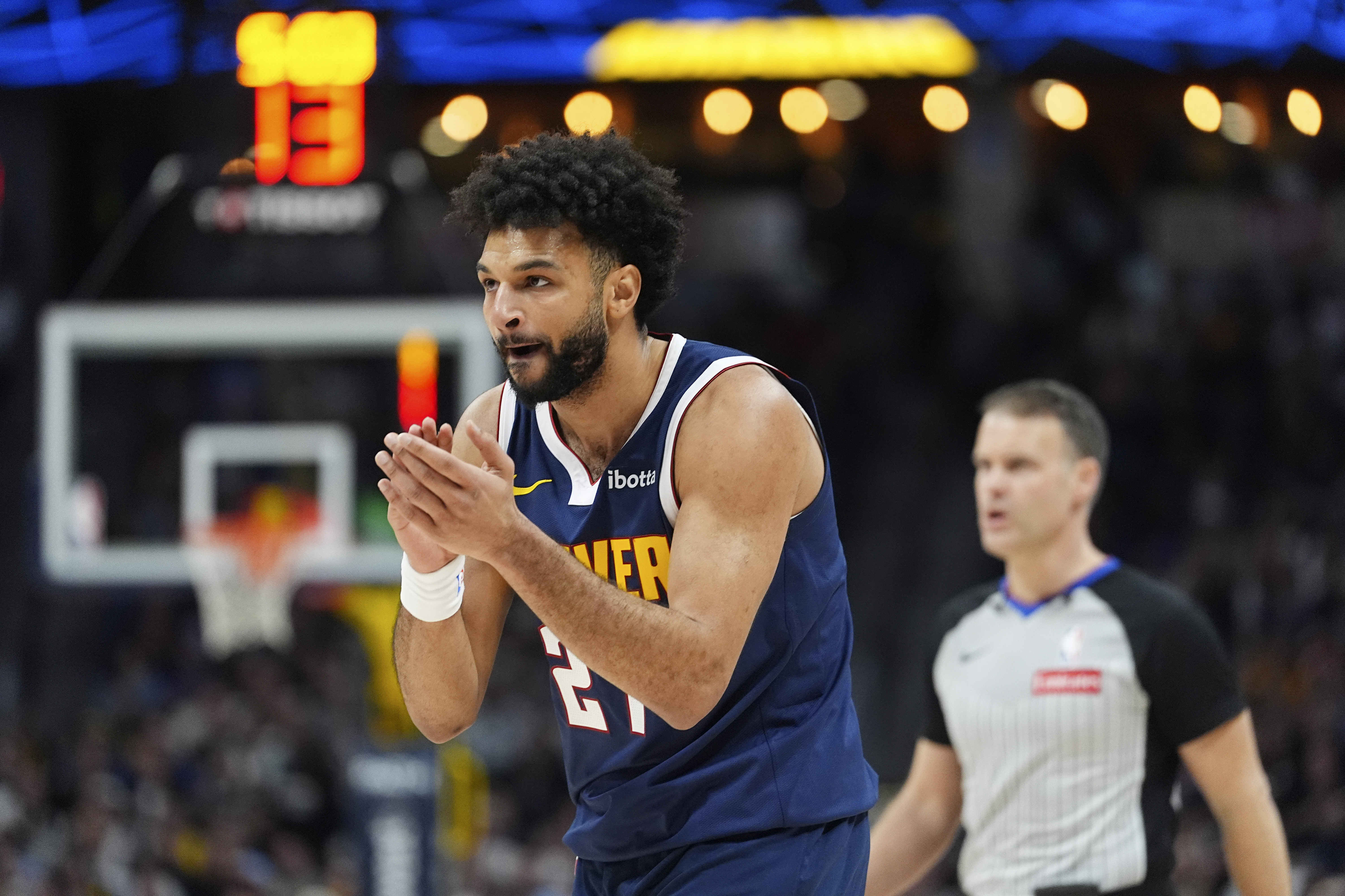 Denver Nuggets guard Jamal Murray reacts after hitting a 3-point basket against the Charlotte Hornets in the first half of an NBA basketball game Thursday, Feb. 20, 2025, in Denver.