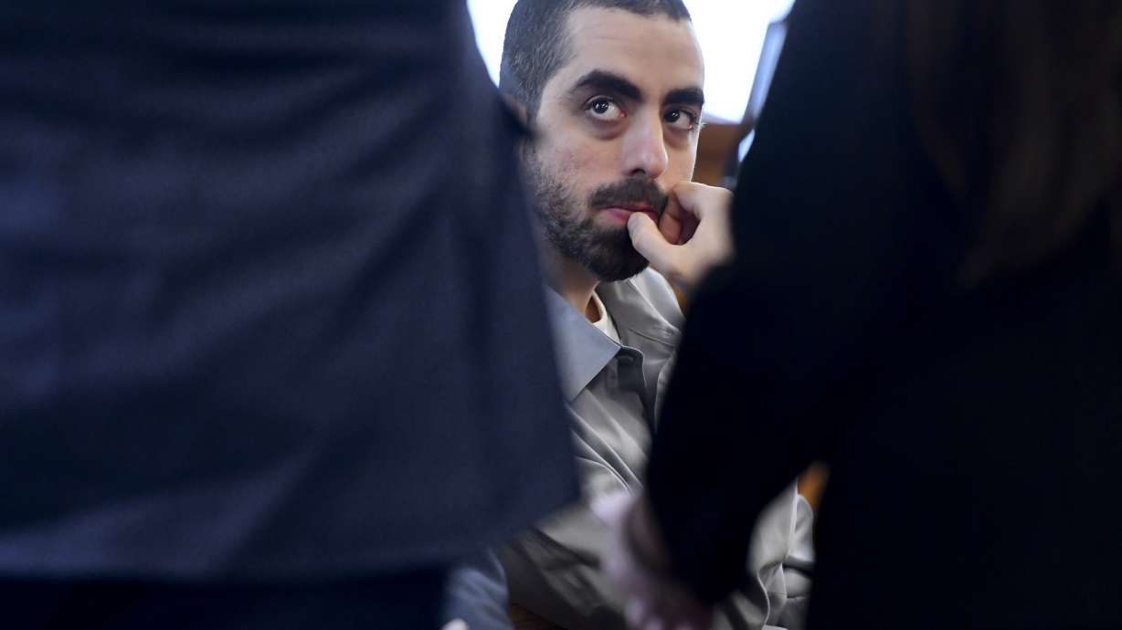 Hadi Matar, charged with severely injuring author Salman Rushdie in a 2022 knife attack, listens to his defense team in a Chautauqua County court in Mayville, N.Y., Feb. 20, 2025.