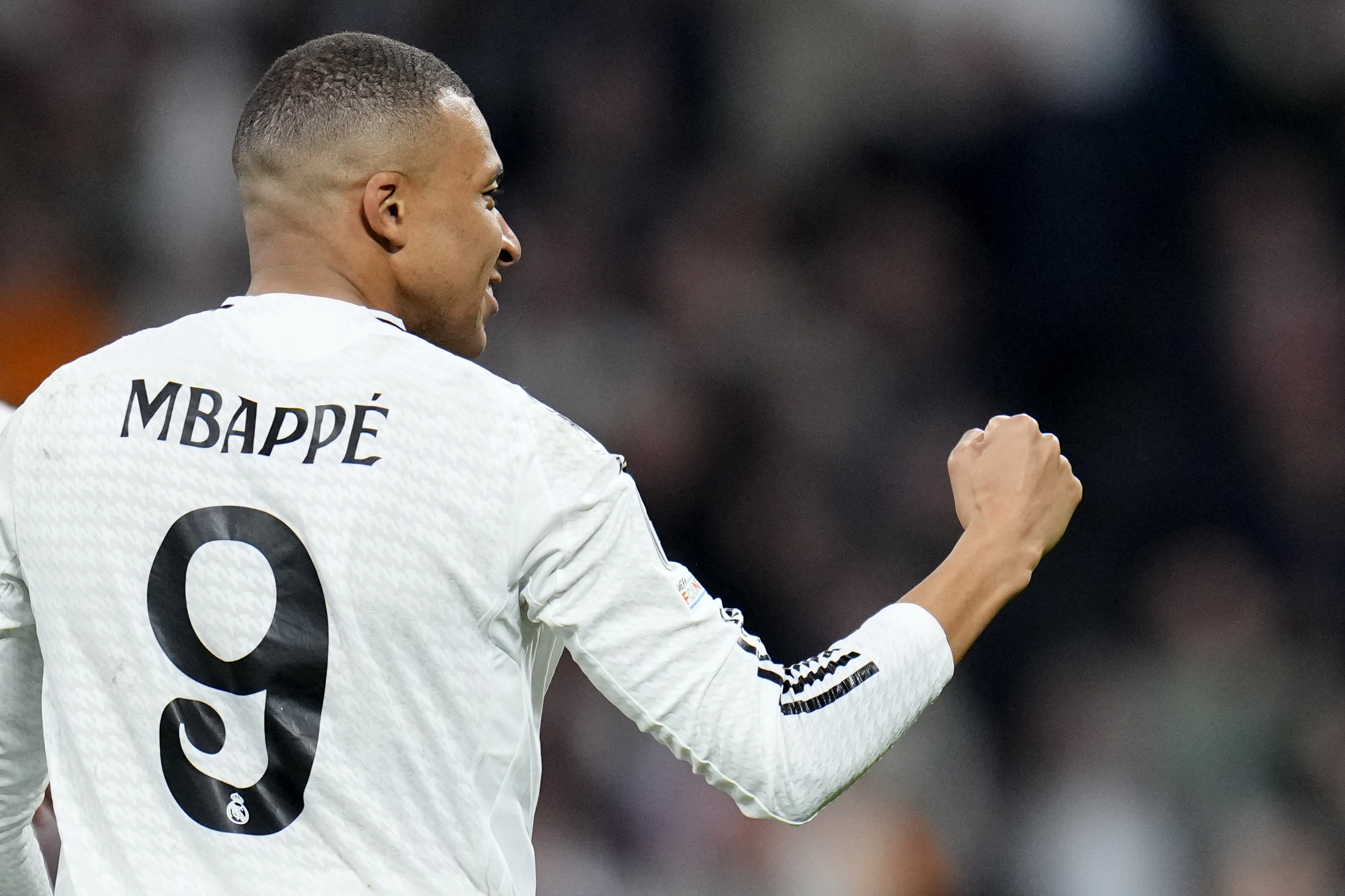 Real Madrid's Kylian Mbappe celebrates after scoring his sides third goal during the Champions League playoff second leg soccer match between Real Madrid and Manchester City at the Santiago Bernabeu Stadium in Madrid, Spain, Wednesday, Feb. 19, 2025.
