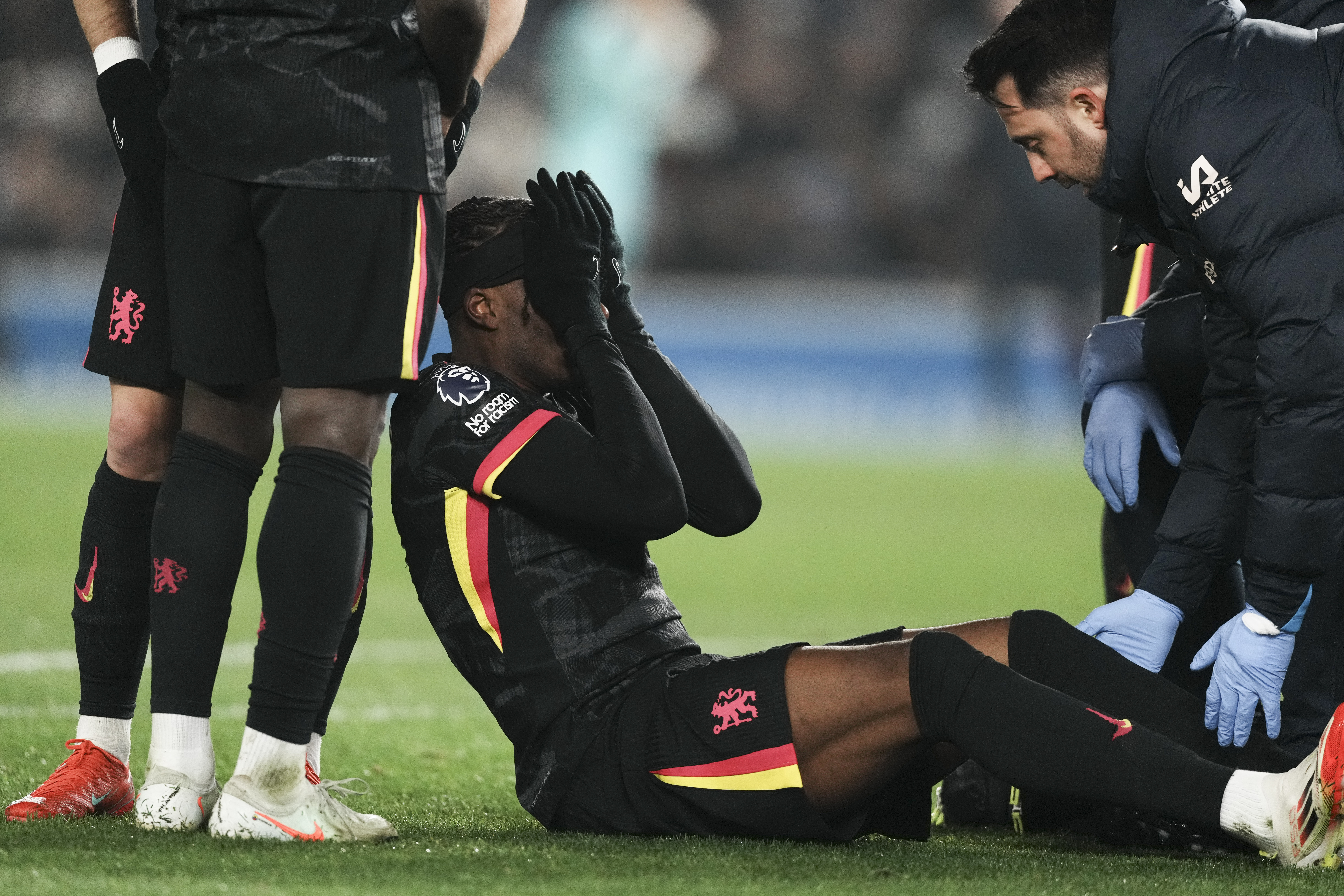 Chelsea's Noni Madueke reacts after an injury during the English Premier League soccer match between Brighton and Chelsea in Brighton, England, Friday, Feb. 14, 2025. 