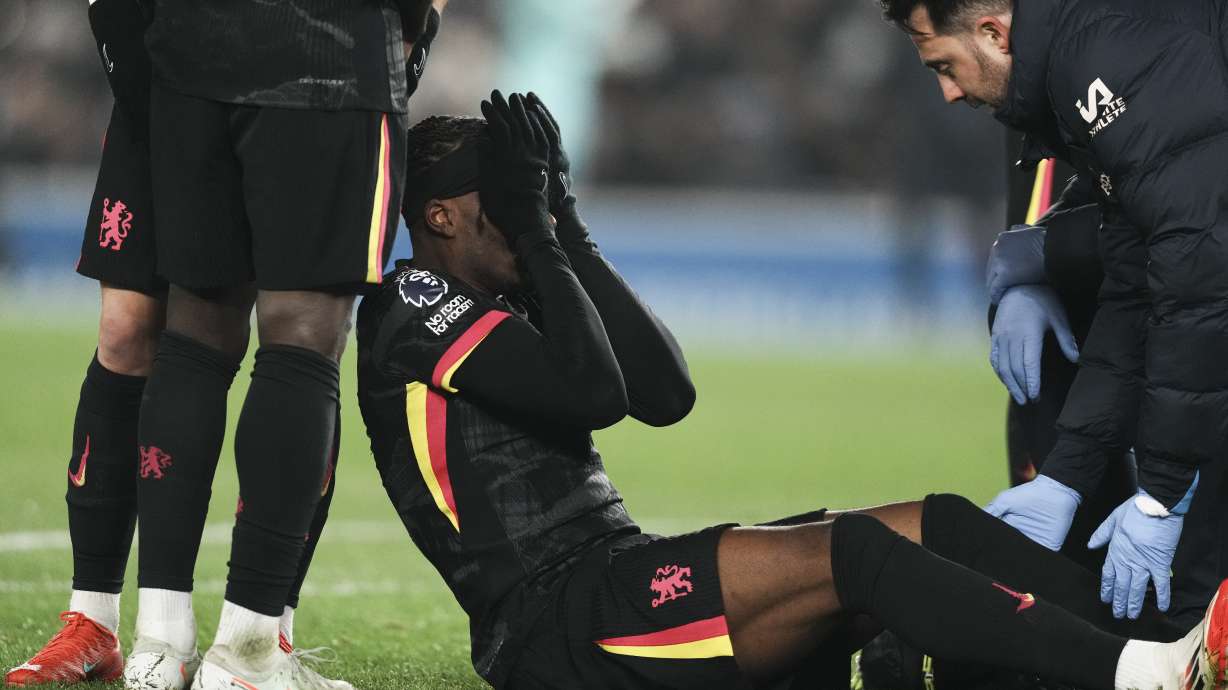 Chelsea's Noni Madueke reacts after an injury during the English Premier League soccer match between Brighton and Chelsea in Brighton, England, Friday, Feb. 14, 2025.