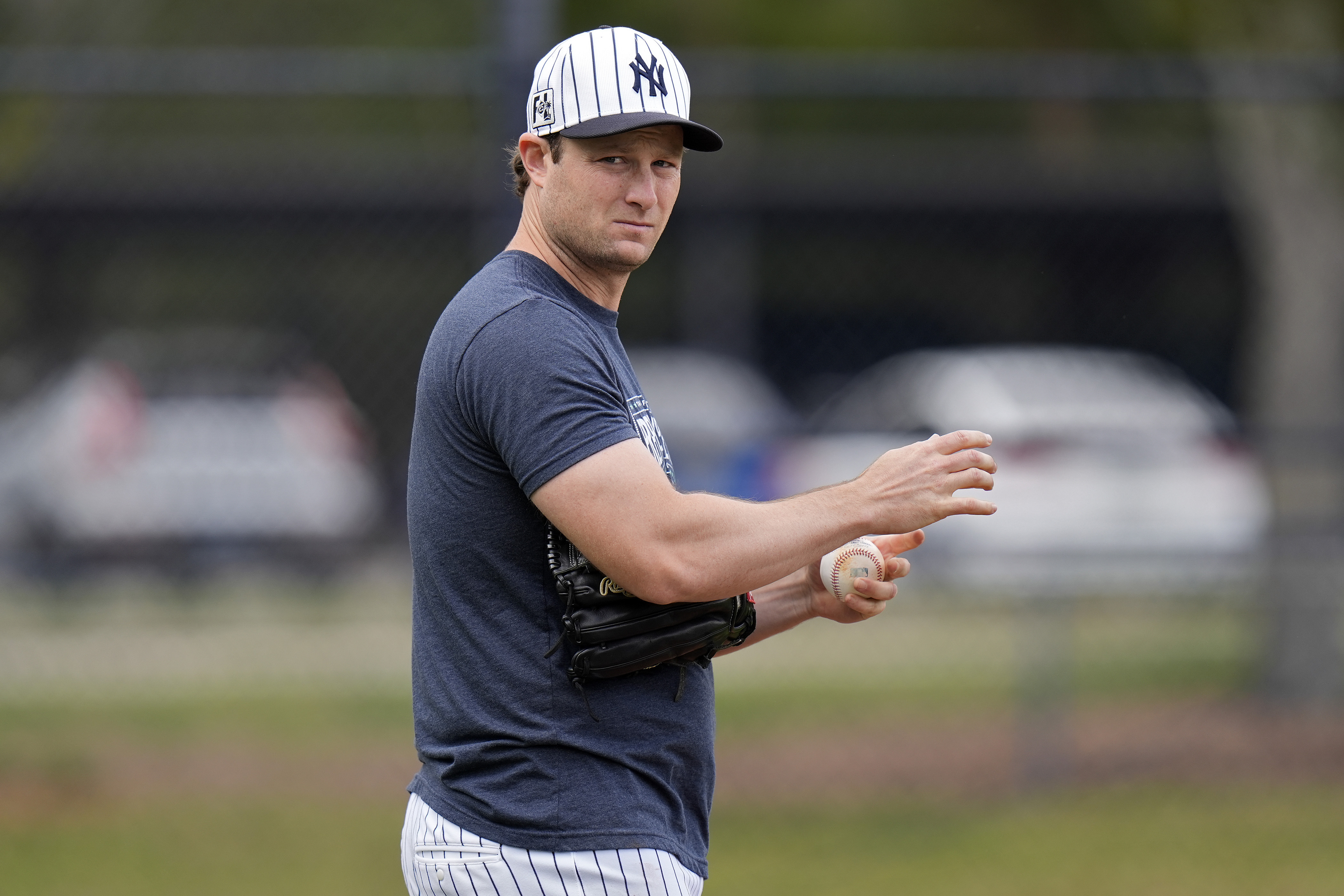 New York Yankees pitcher Gerrit Cole takes part in pickoff drills during a spring training baseball workout Thursday, in Tampa, Fla.