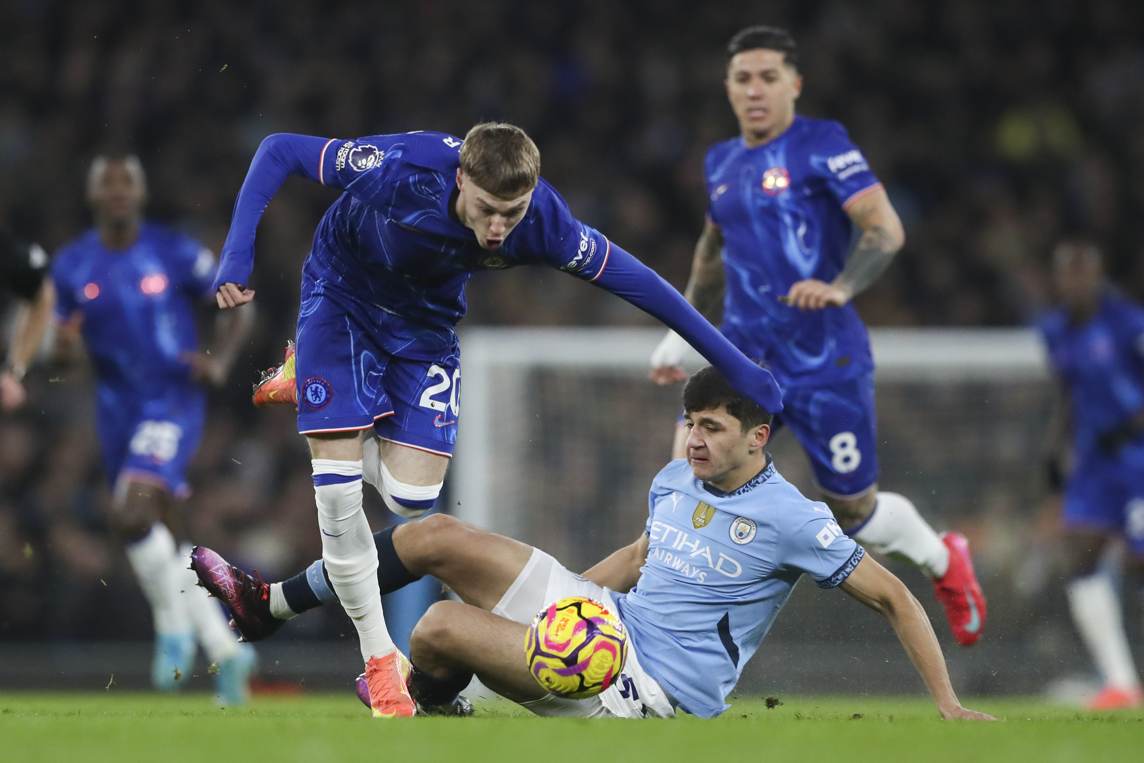 Chelsea's Cole Palmer, left, duels for the ball with Manchester City's Abdukodir Khusanov during the English Premier League soccer match between Manchester City and Chelsea at Etihad Stadium in Manchester, England, Saturday, Jan. 25, 2025.