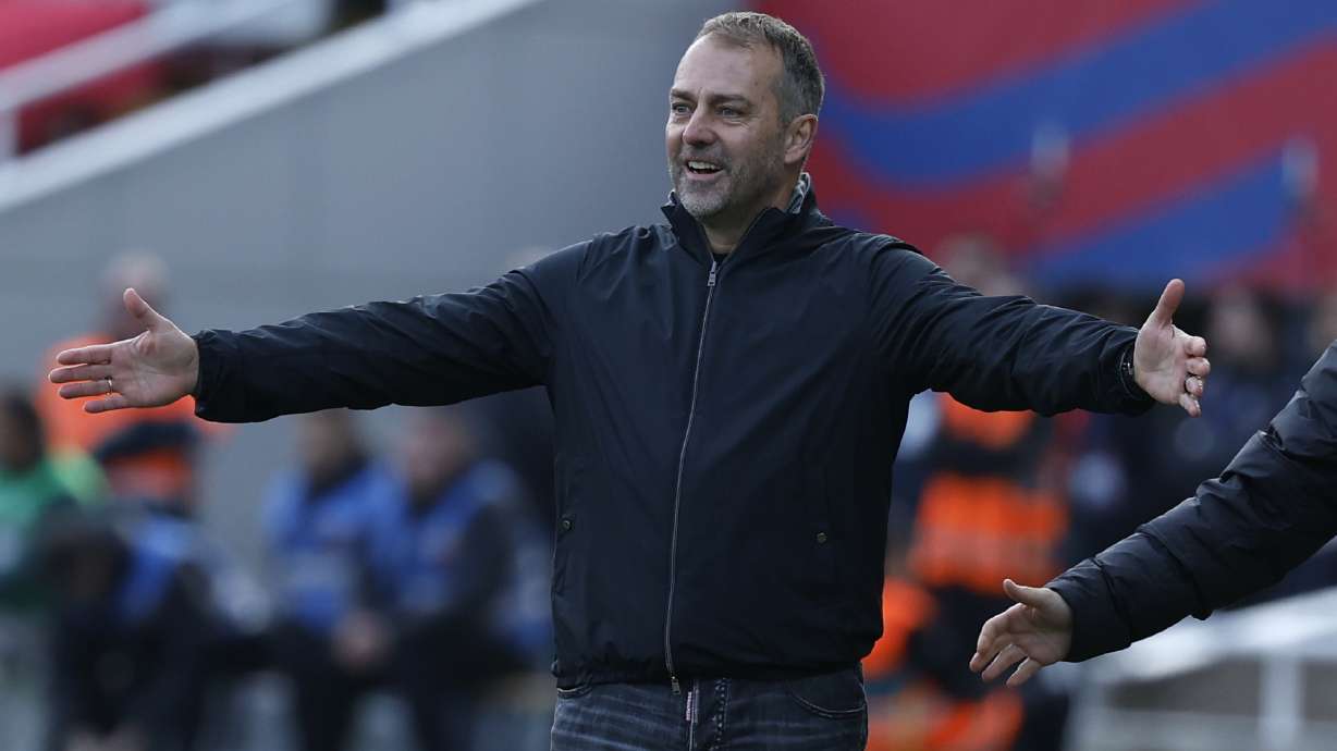 Barcelona's head coach Hansi Flick gestures during a Spanish La Liga soccer match between Barcelona and Alaves at the Lluis Companys Olympic Stadium in Barcelona, Spain, Sunday Feb. 2, 2025.
