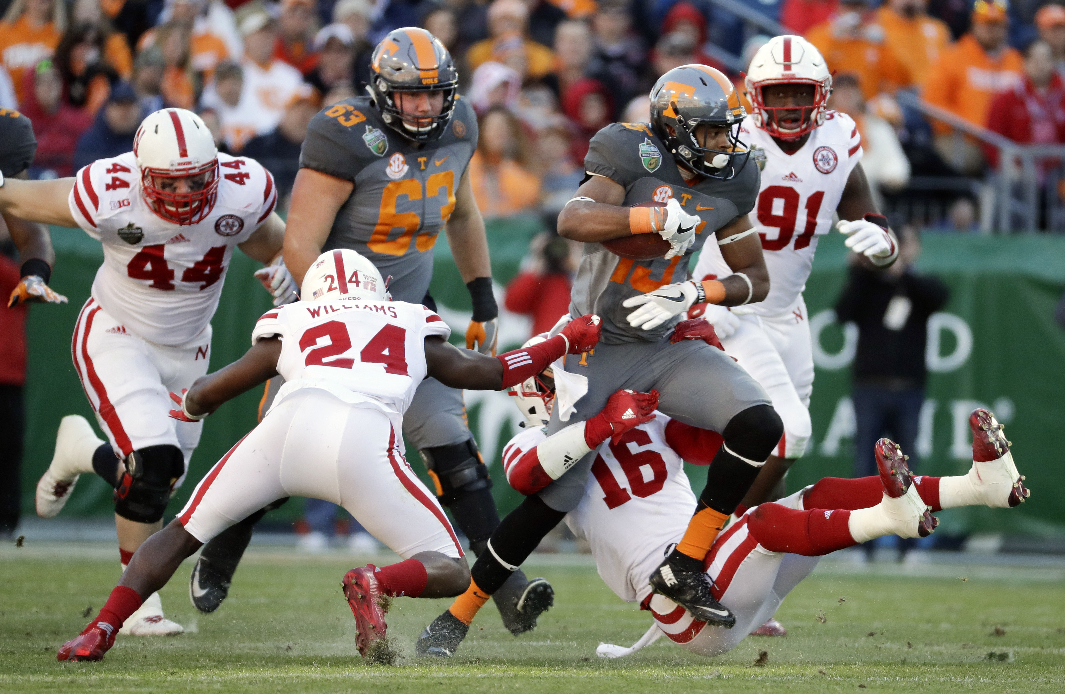 FILE - Tennessee wide receiver Jauan Jennings (15) tries to get past Nebraska defenders Aaron Williams (24) and Antonio Reed (16) in the first half of the Music City Bowl NCAA college football game, Dec. 30, 2016, in Nashville, Tenn. 