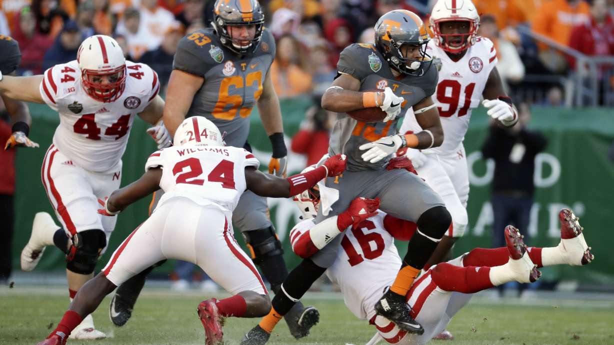 FILE - Tennessee wide receiver Jauan Jennings (15) tries to get past Nebraska defenders Aaron Williams (24) and Antonio Reed (16) in the first half of the Music City Bowl NCAA college football game, Dec. 30, 2016, in Nashville, Tenn.