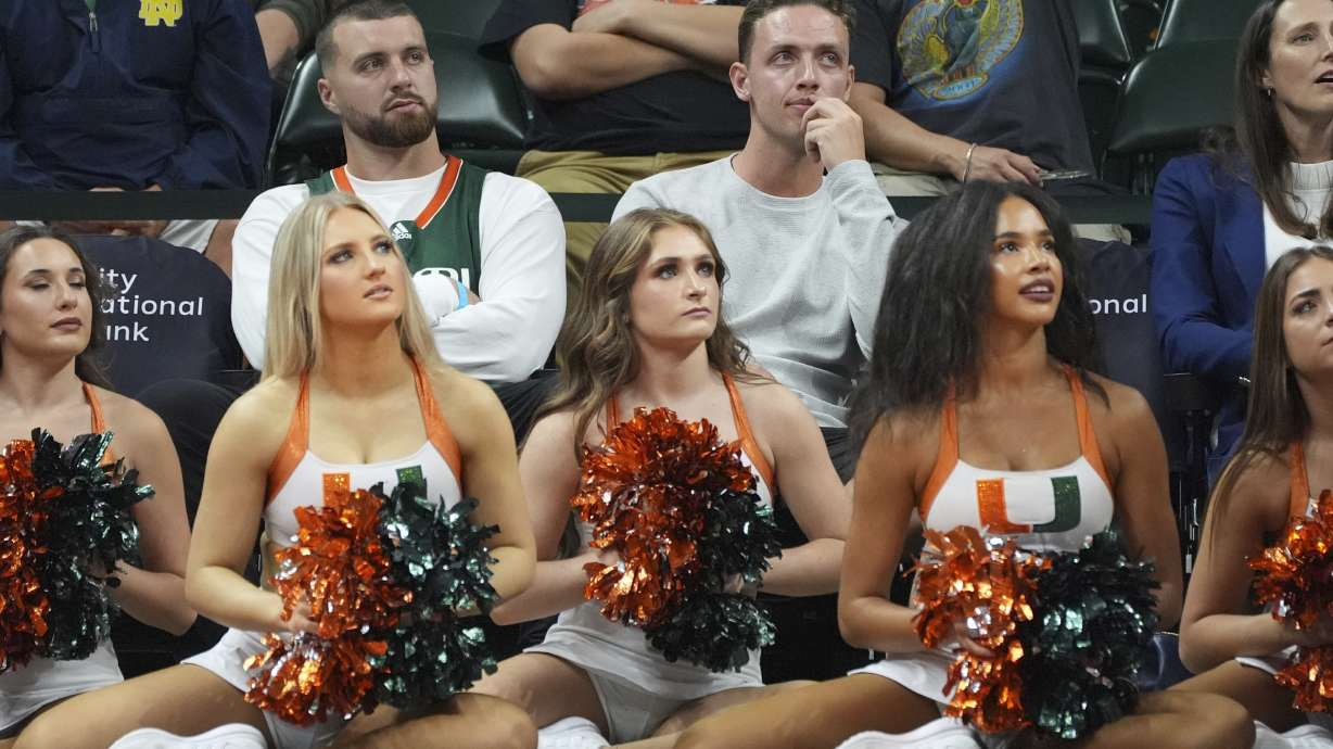 Miami football quarterback Carson Beck, top center, watches the first half of an NCAA college basketball game between Miami and Notre Dame, Thursday, Feb. 20, 2025, in Coral Gables, Fla.