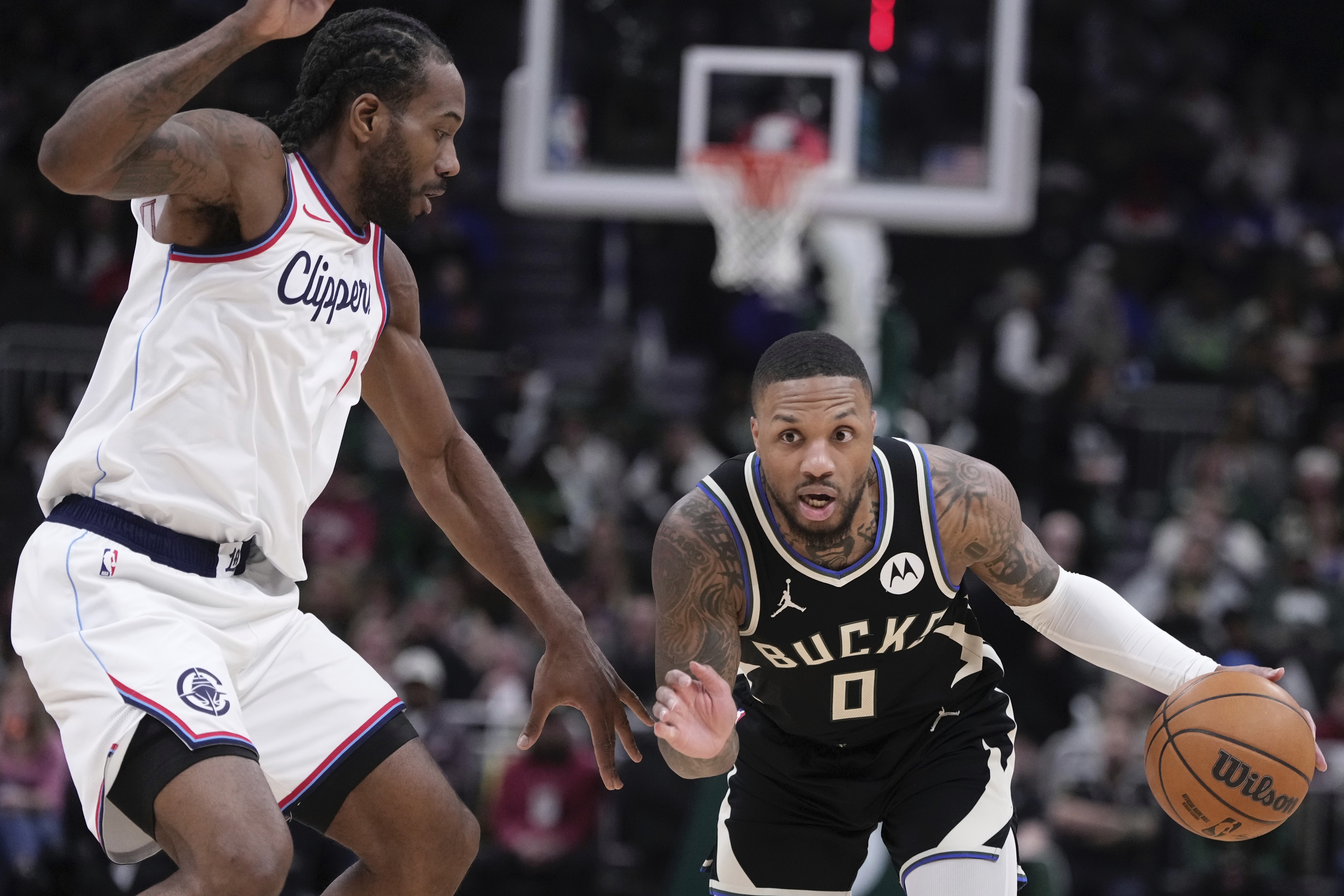 Milwaukee Bucks' Damian Lillard tries to get past LA Clippers' Kawhi Leonard during the first half of an NBA basketball game Thursday, Feb. 20, 2025, in Milwaukee. 