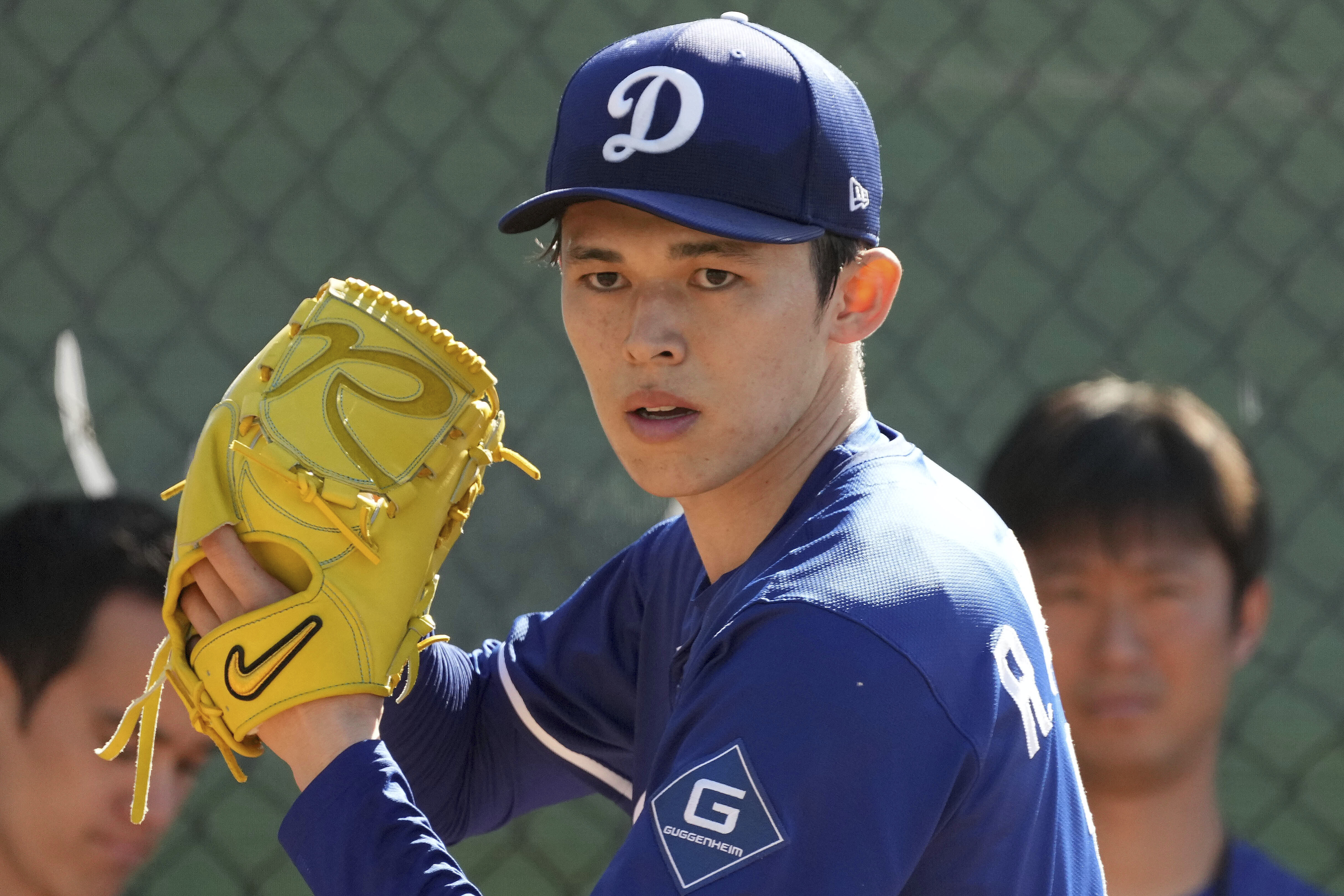 Los Angeles Dodgers pitcher Roki Sasaki (11) throws during his first live bullpen session during spring training baseball practice, Wednesday, Feb. 19, 2025, in Phoenix.