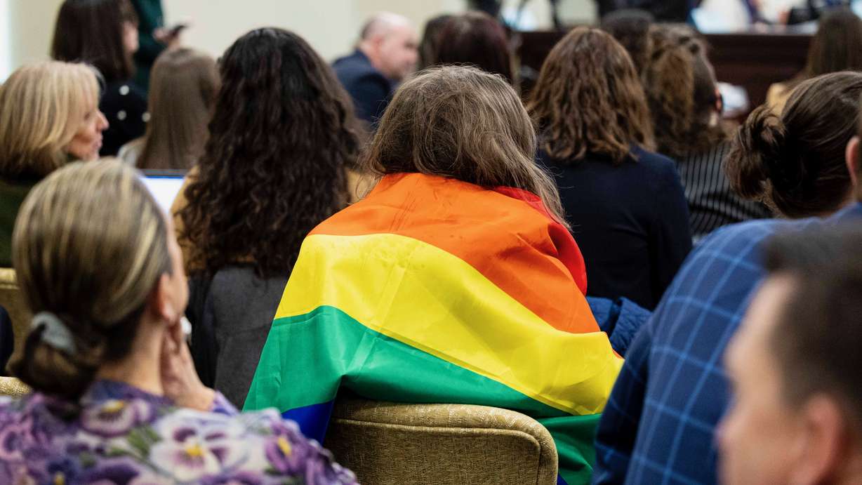 Utah lawmakers debated HB77, which would ban certain flags in classrooms, on Friday. In the Feb. 13 photo, Nova Adstrum, of Sandy, wears an LGBTQ pride flag at a House Education Committee meeting on HB77 in the Senate Building in Salt Lake City.