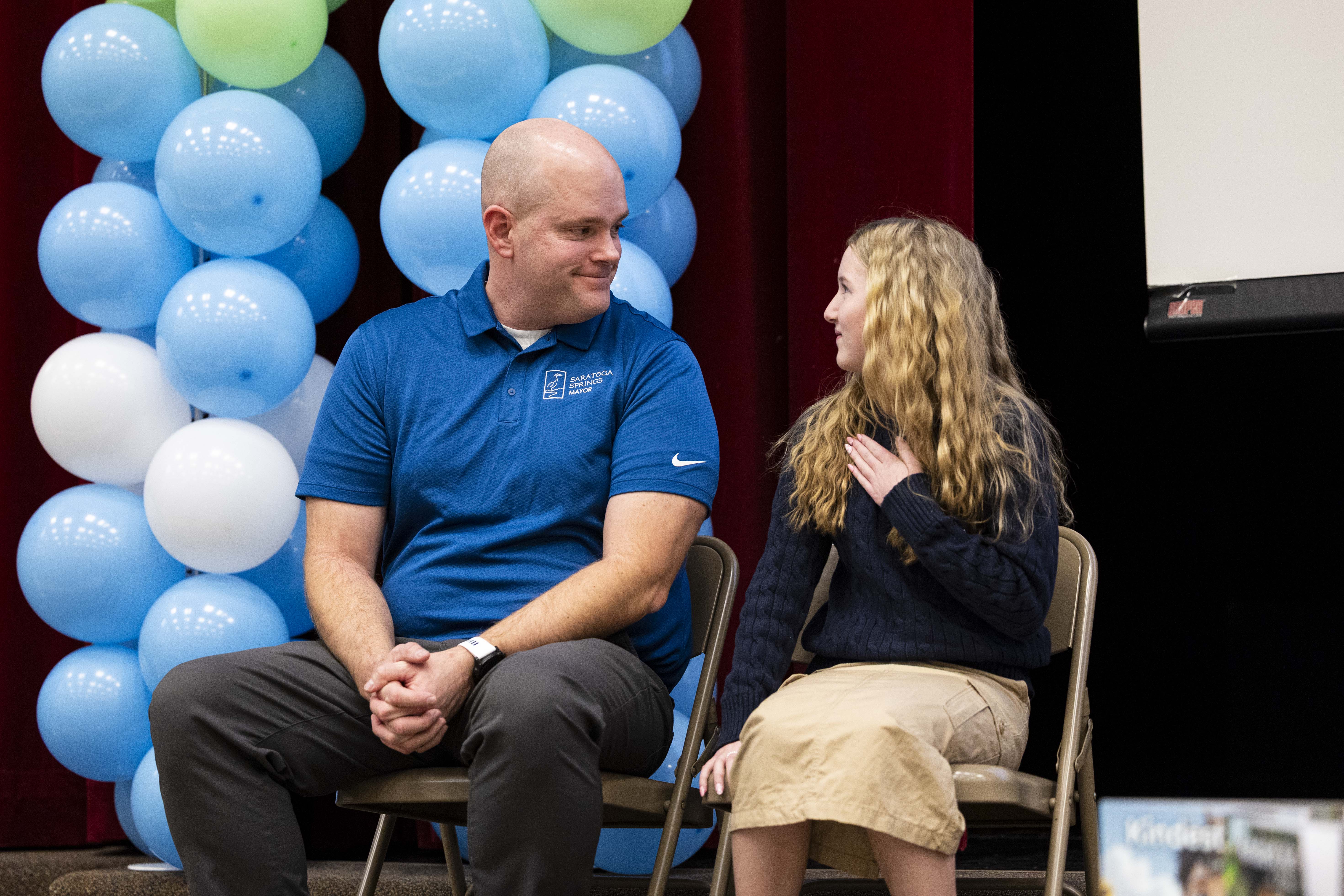 Sixth-grader Aspen Rowley, 12, talks with Saratoga Springs Mayor Jim Miller during an assembly presenting the "Kindest Kid in America" award to Rowley at Sage Hills Elementary School in Saratoga Springs on Friday.