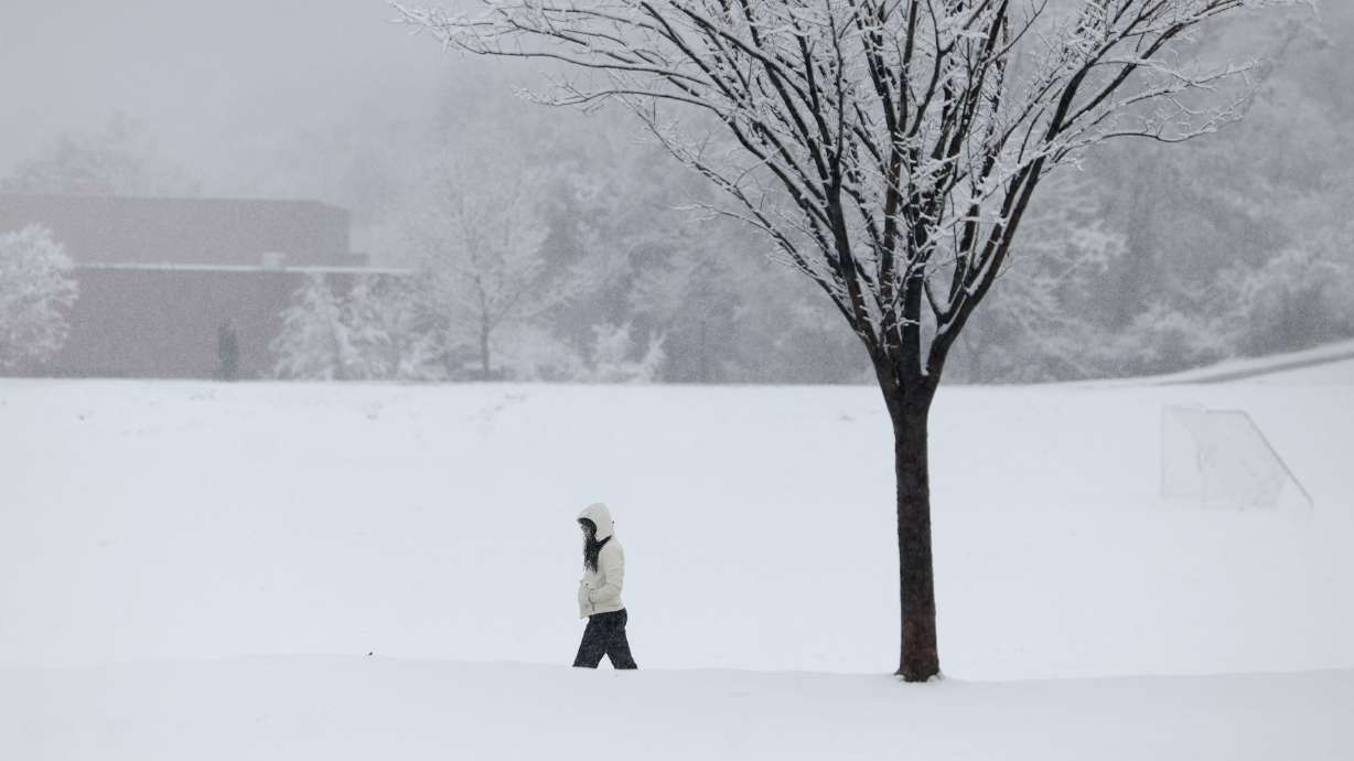 Anna Johnson, of Salt Lake City, walks through snow at 11th Avenue Park in Salt Lake City on Thursday. Long-range models suggest meteorological spring, which begins on March 1, could continue to produce some storms but could also be warmer and drier than normal.