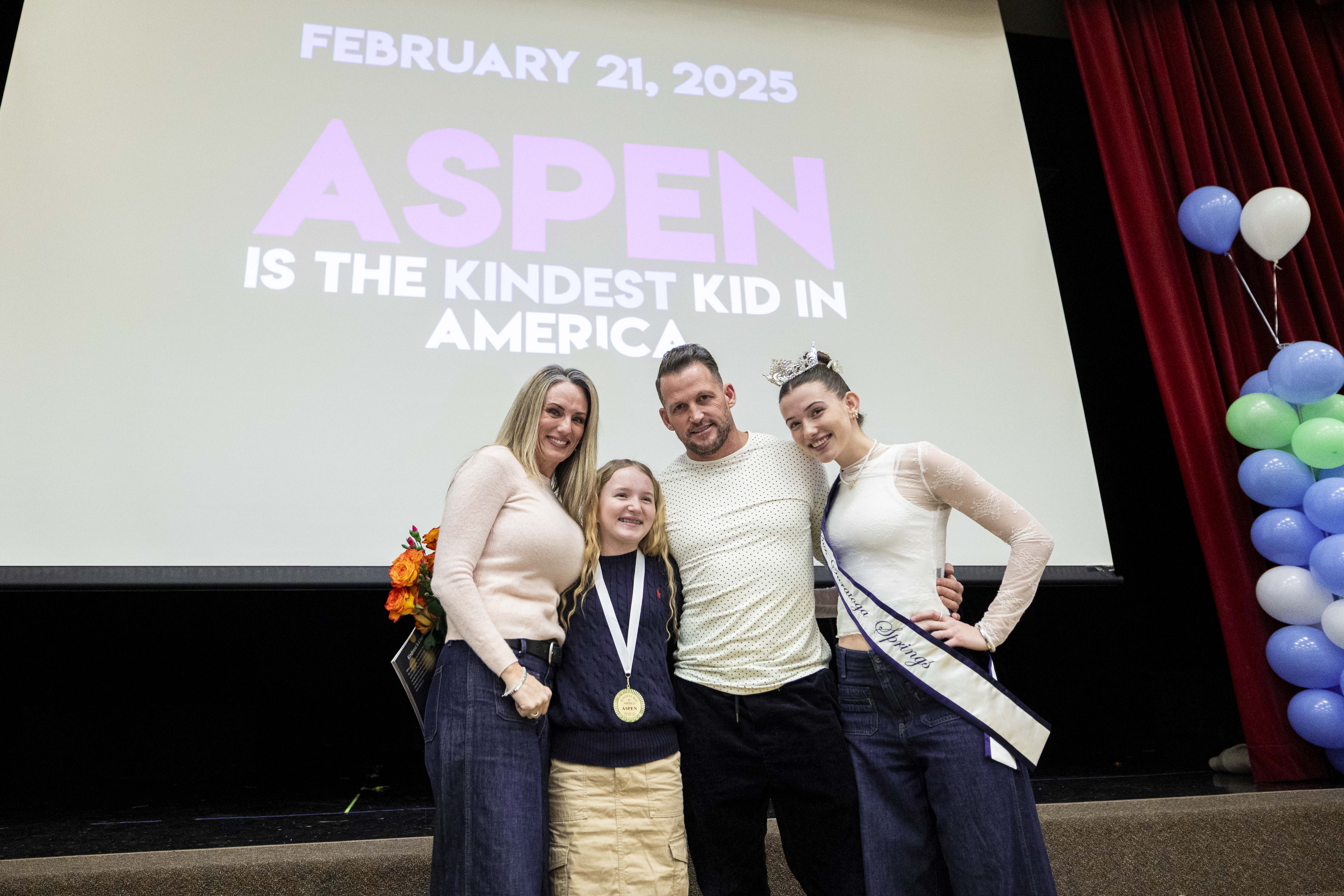 Sixth-grader Aspen Rowley, 12, poses for photos with her family, from left, Toni Rowley, Colby Rowley and Reagan Rowley after an assembly presenting the "Kindest Kid in America" award to Aspen held at Sage Hills Elementary School in Saratoga Springs on Friday.