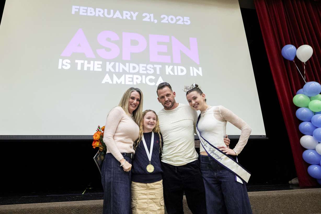 Sixth-grader Aspen Rowley, 12, poses for photos with her family, from left, Toni Rowley, Colby Rowley and Reagan Rowley after an assembly presenting the "Kindest Kid in America" award to Aspen held at Sage Hills Elementary School in Saratoga Springs on Friday.