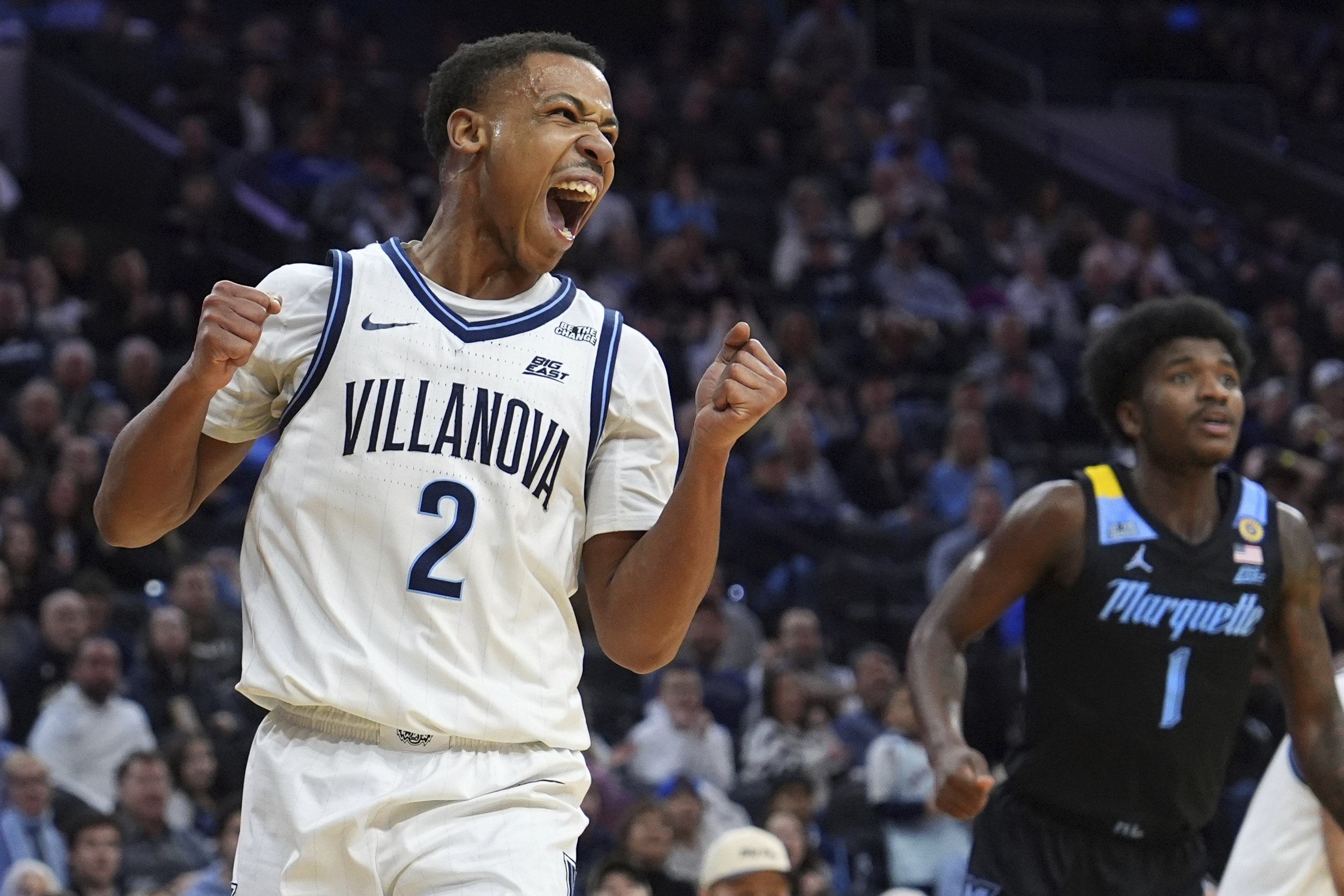 Villanova's Jhamir Brickus, left, reacts past Marquette's Kam Jones during the first half of an NCAA college basketball game, Friday, Feb. 21, 2025, in Philadelphia. 