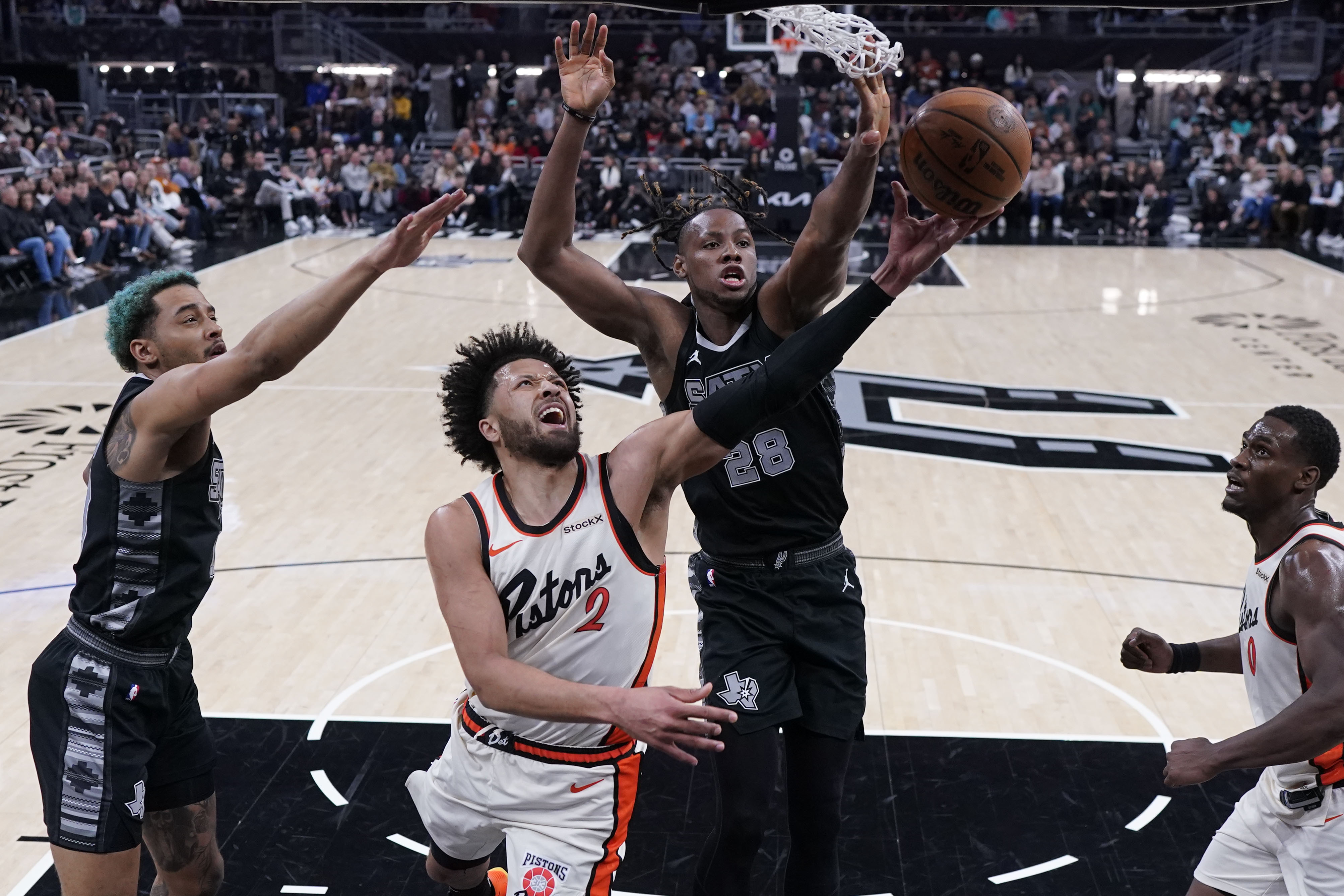 Detroit Pistons guard Cade Cunningham (2) tries to score against San Antonio Spurs center Charles Bassey (28) during the first half of an NBA basketball game in Austin, Texas, Friday, Feb. 21, 2025.