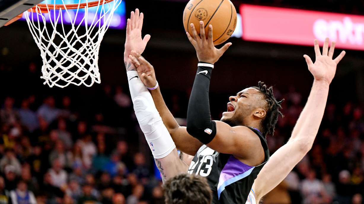 Utah Jazz guard Isaiah Collier (13) battles Oklahoma City Thunder center Isaiah Hartenstein (55) as he tries for a shot as the Jazz and Thunder play in Salt Lake City at the Delta Center on Friday, Feb. 21, 2025.
