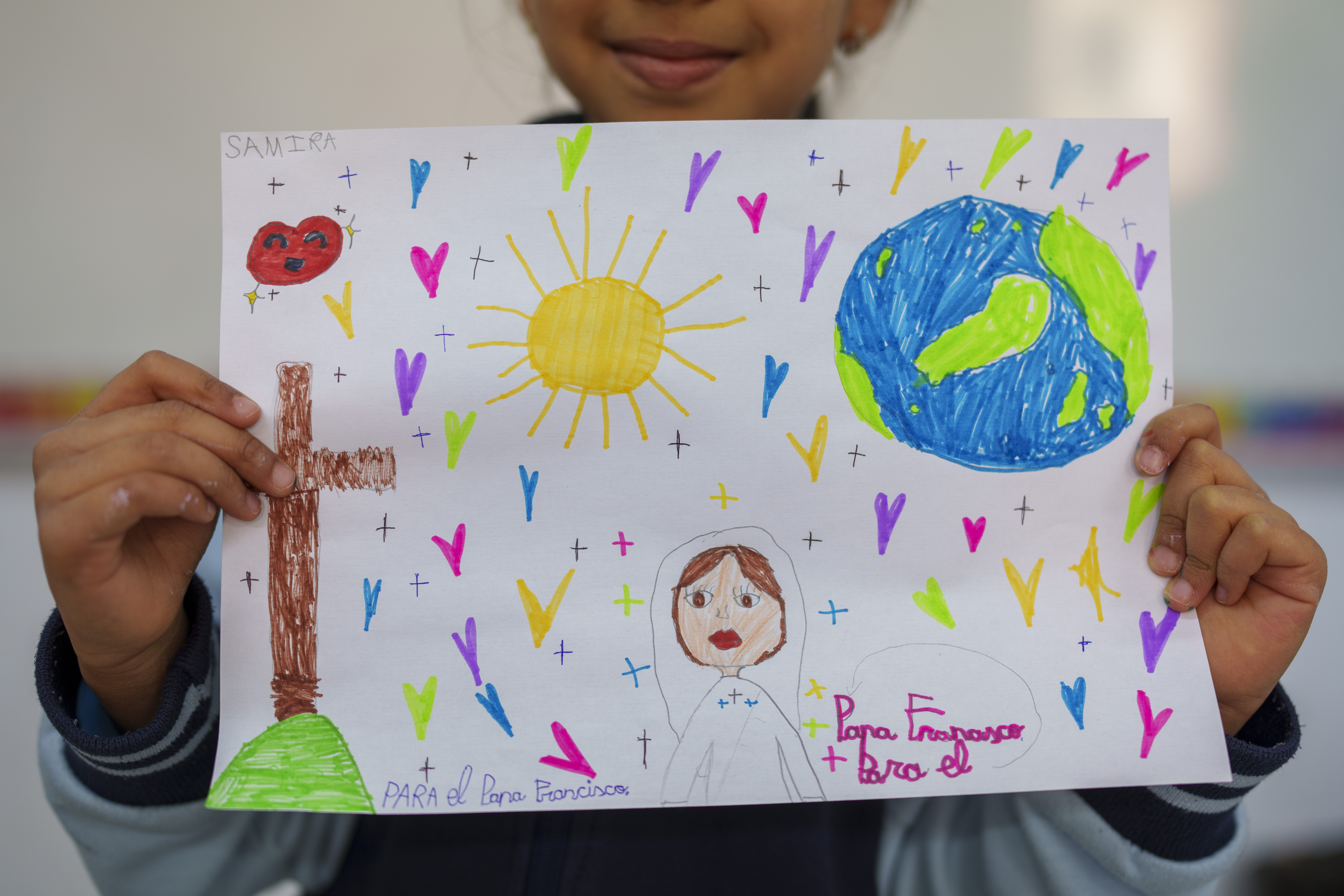 Samira, 8, shows s a picture reading in Spanish: "For the Pope Francisco" as part of an initiative to encourage Pope Francisco in his recovery, in Madrid, Spain, on Friday.