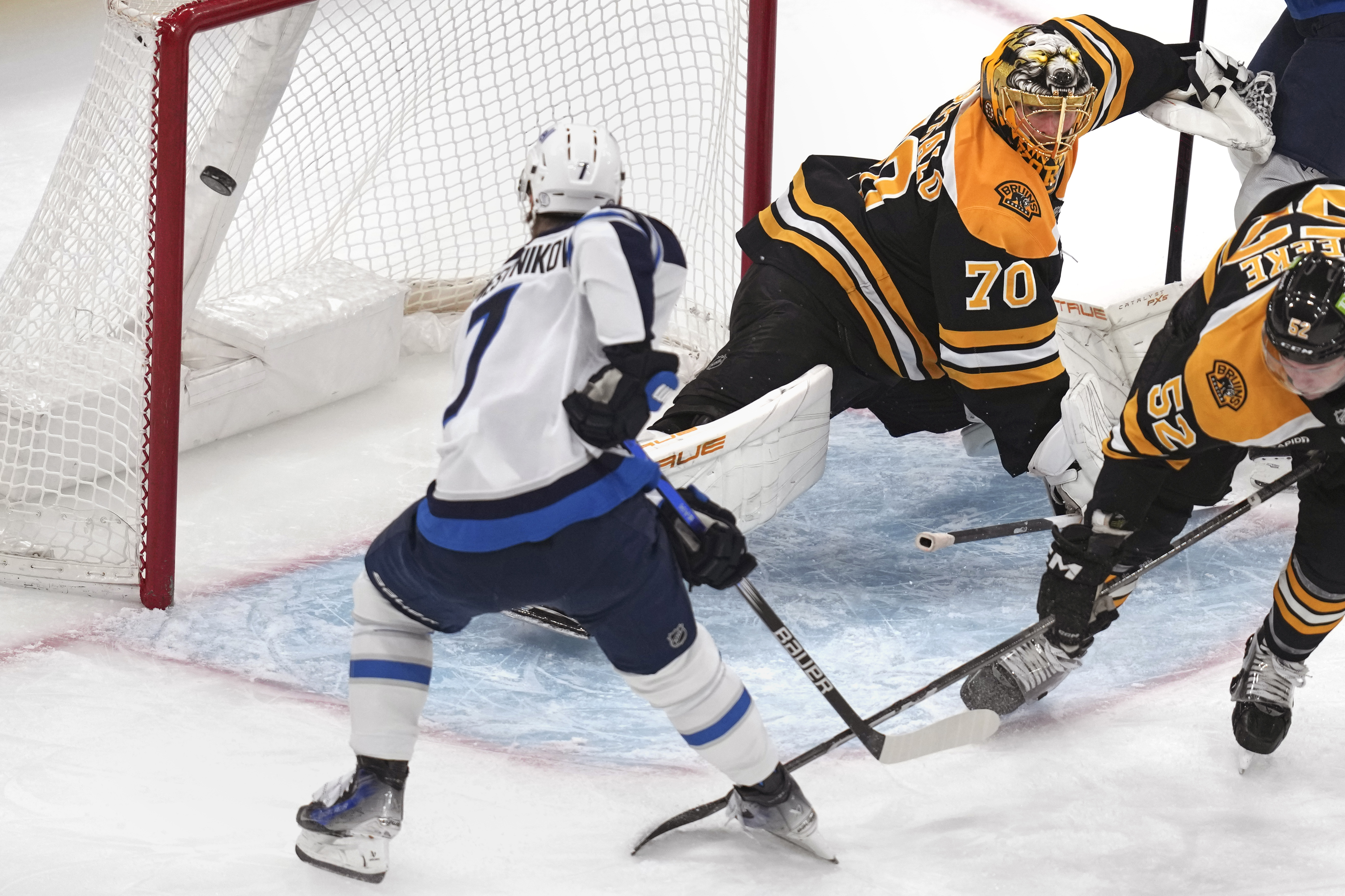 Winnipeg Jets center Vladislav Namestnikov (7) backhands a shot for a goal against Boston Bruins goaltender Joonas Korpisalo (70) during the first period of an NHL hockey game, Thursday, Jan. 30, 2025, in Boston. 