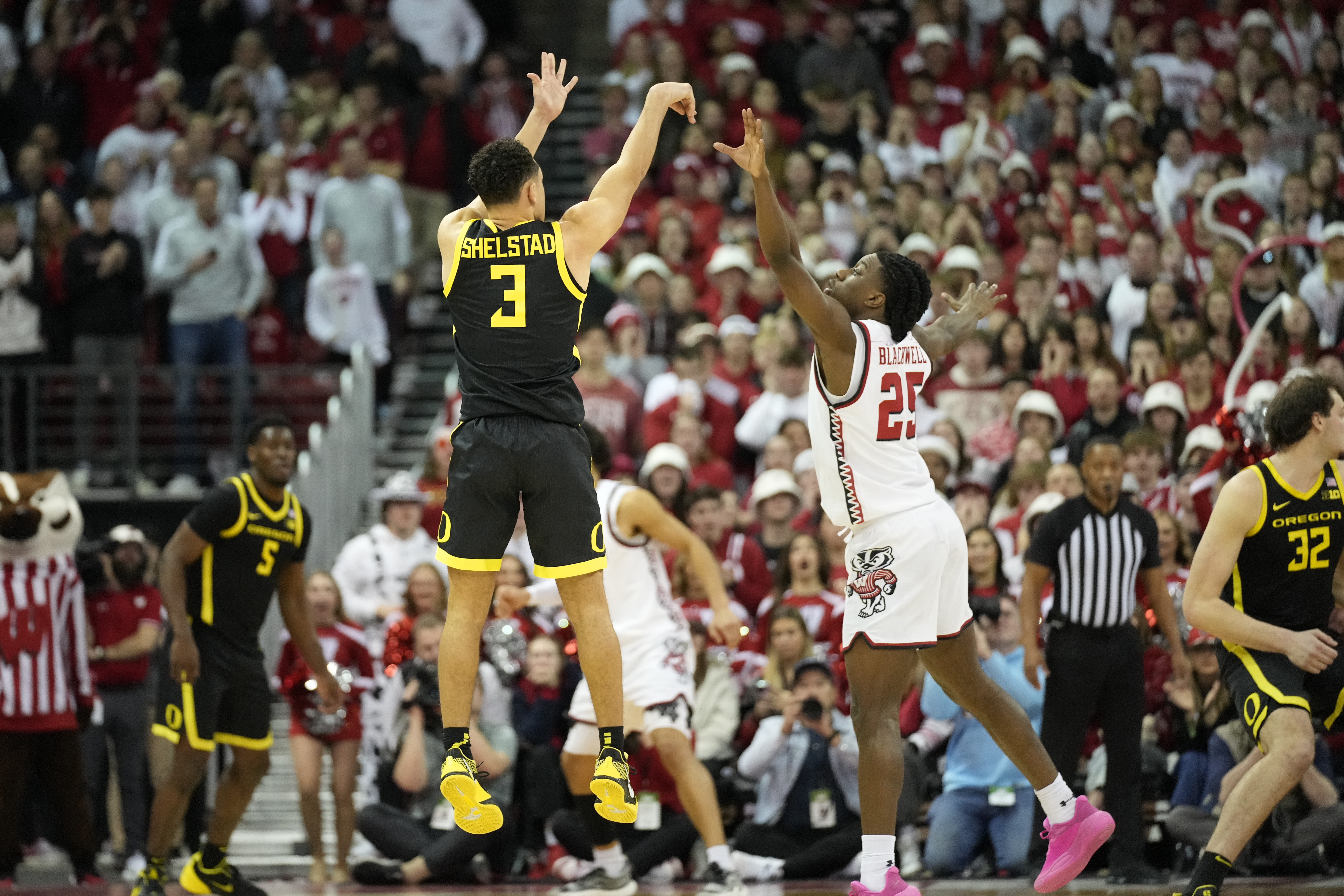 Oregon guard Jackson Shelstad (3) makes a 3-point basket to tie up the game against Wisconsin guard John Blackwell (25) during the second half of an NCAA college basketball game Saturday, Feb. 22, 2025, in Madison, Wis. 