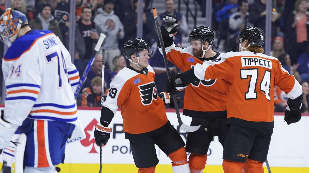 Philadelphia Flyers' Owen Tippett, from right, Sean Couturier and Matvei Michkov celebrate after a goal by Couturier against Edmonton Oilers' Stuart Skinner, left, during the second period of an NHL hockey game, Saturday, Feb. 22, 2025, in Philadelphia.