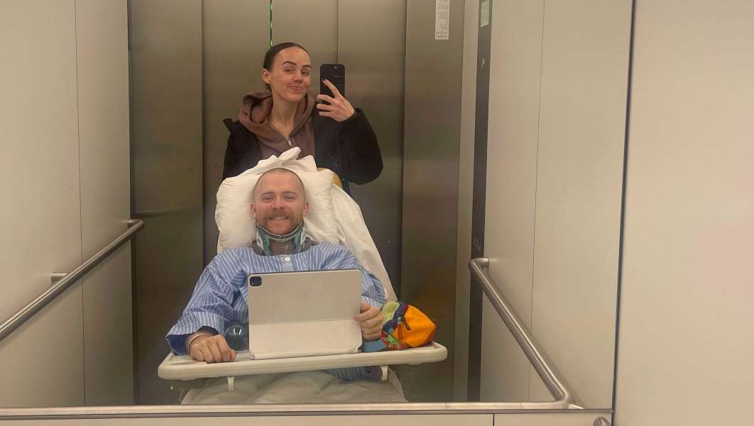 Justin and Jaquoy Holman pose for a photo in an elevator at the University Hospital of Bern in Bern, Switzerland.