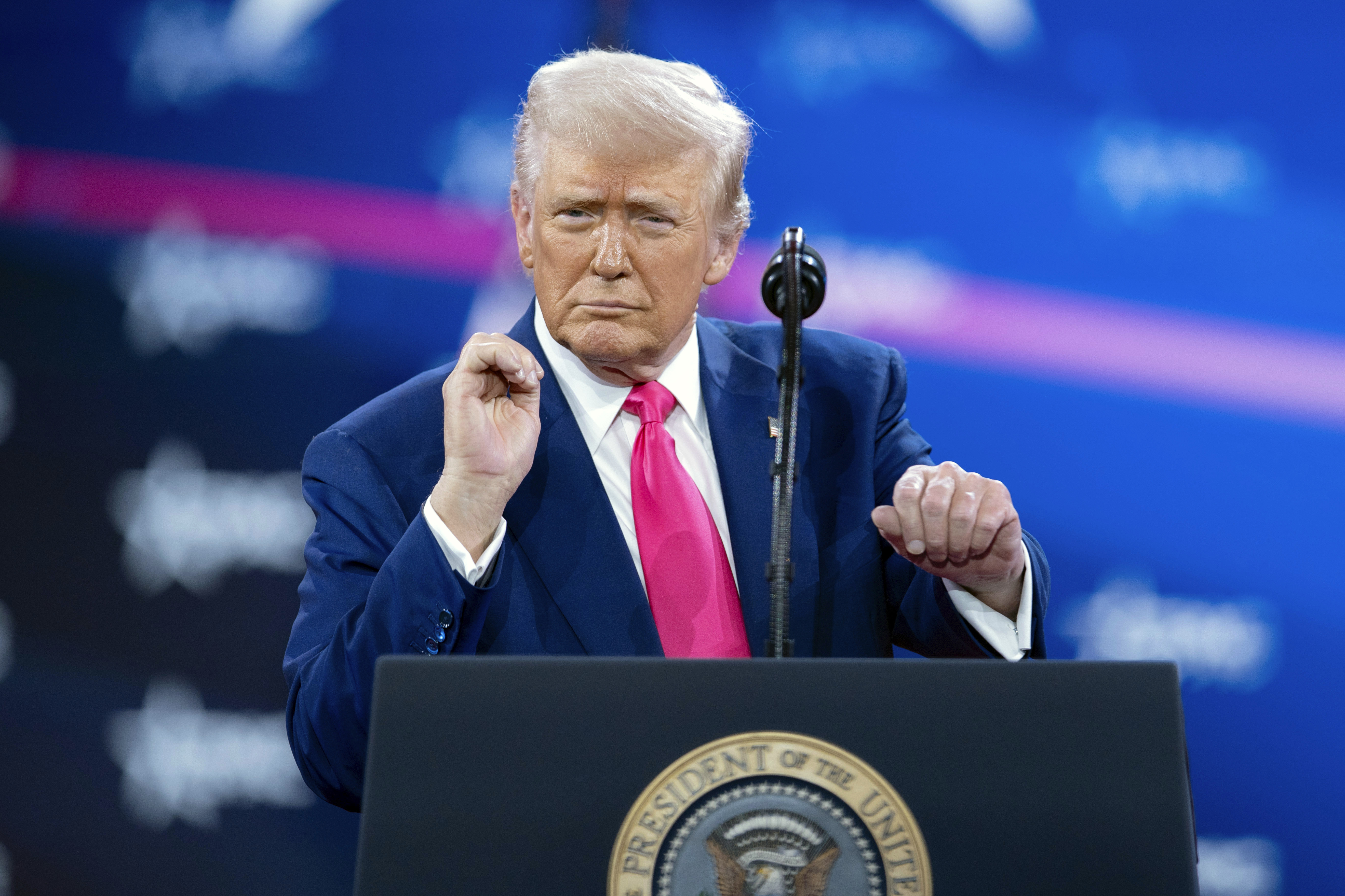 Trump revels in mass federal firings and jeers at Biden before adoring conservative crowd