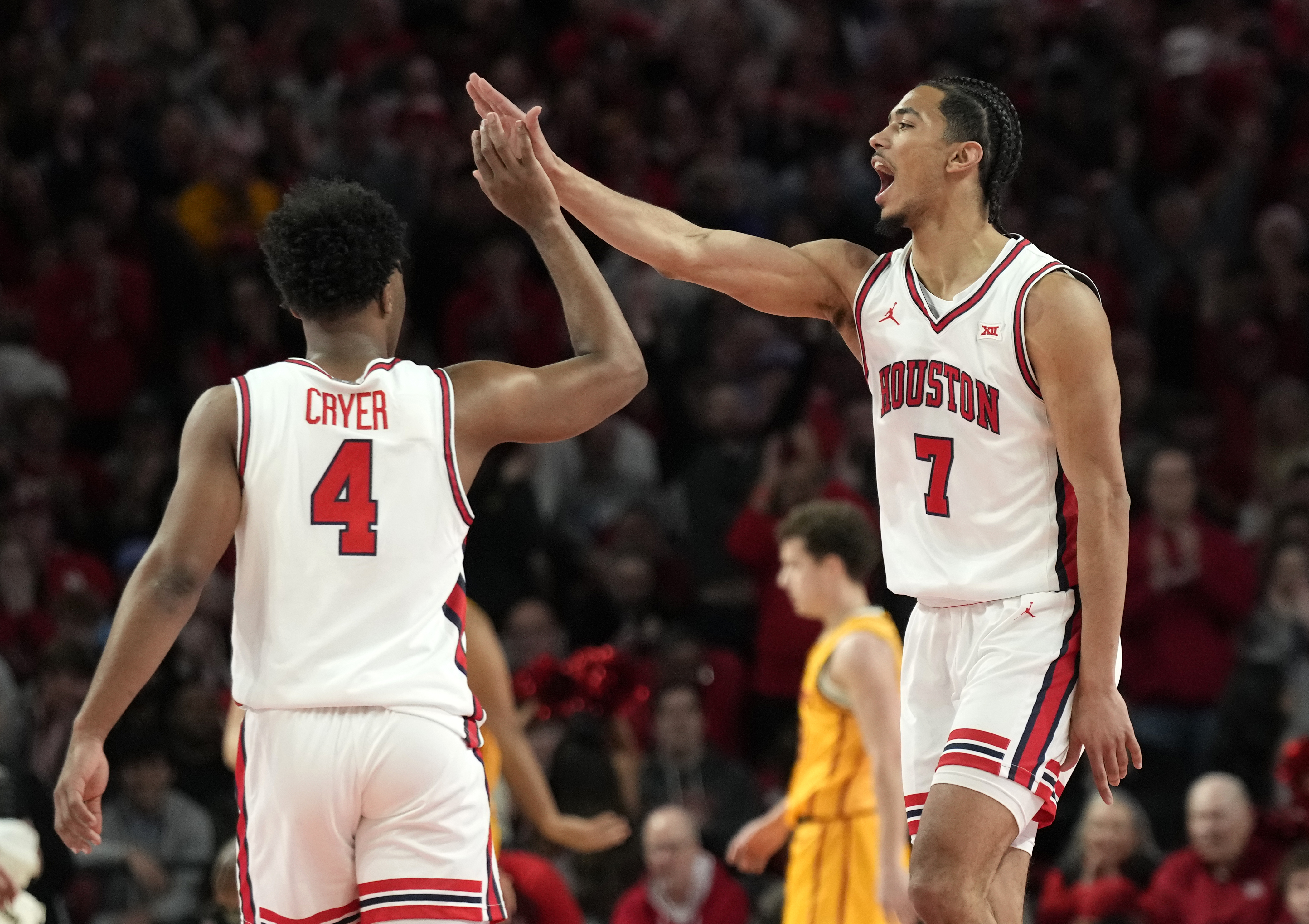 Houston guard Milos Uzan (7) celebrates his 3-pointer with guard L.J. Cryer (4) during the first half of an NCAA college basketball game against Iowa State in Houston, Saturday, Feb. 22, 2025. 