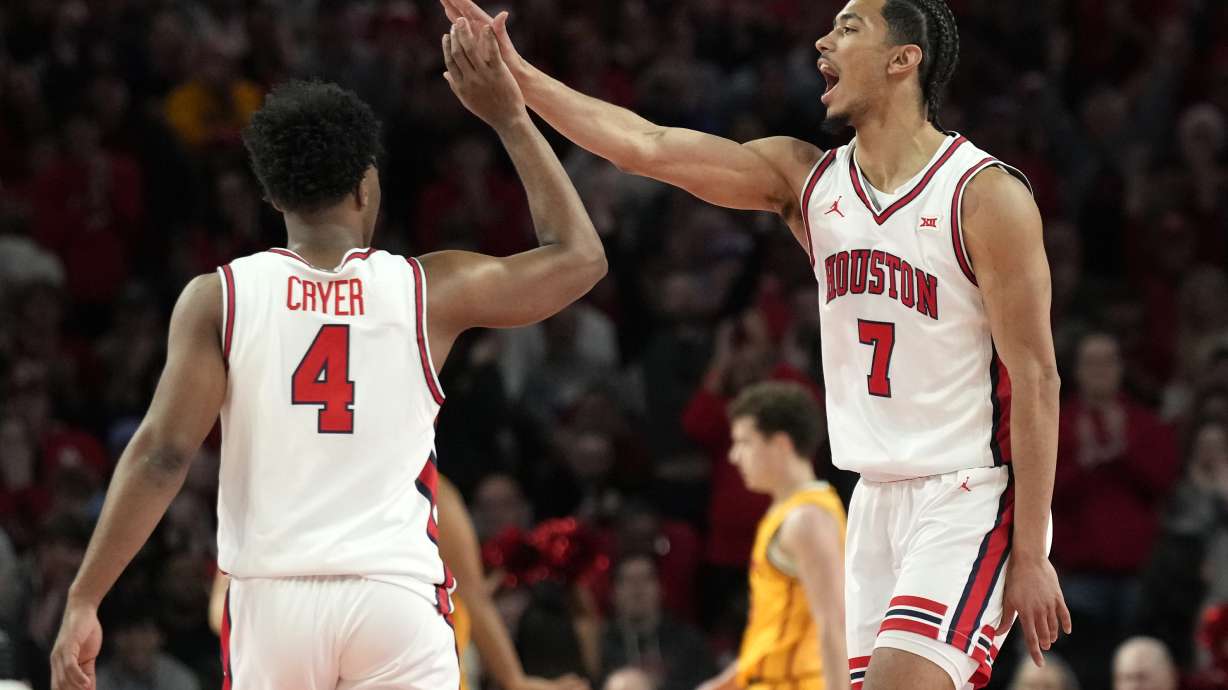 Houston guard Milos Uzan (7) celebrates his 3-pointer with guard L.J. Cryer (4) during the first half of an NCAA college basketball game against Iowa State in Houston, Saturday, Feb. 22, 2025.