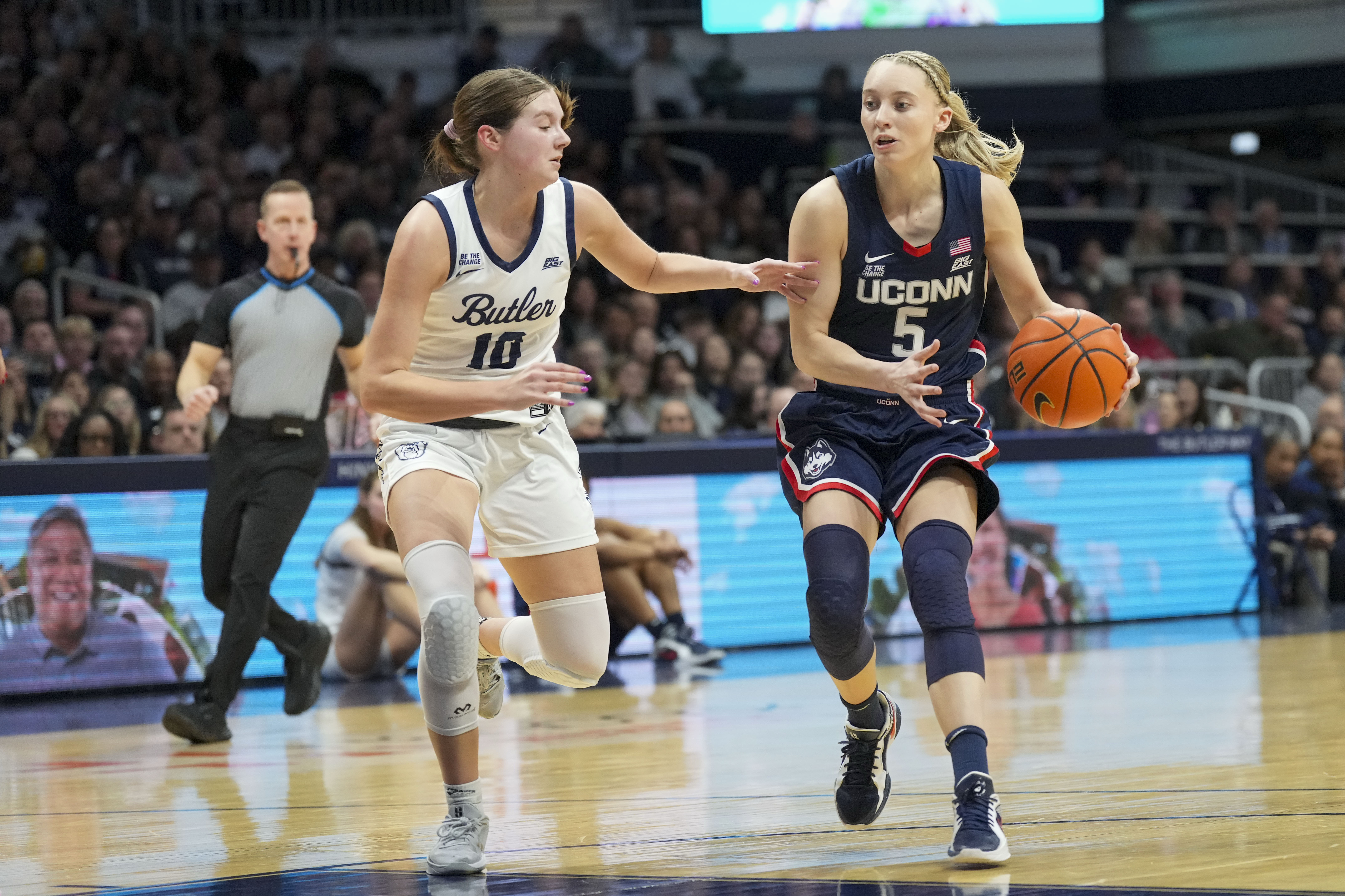 UConn guard Paige Bueckers (5) goes around Butler guard Lily Zeinstra (10) in the first half of an NCAA college basketball game in Indianapolis, Saturday, Feb. 22, 2025.