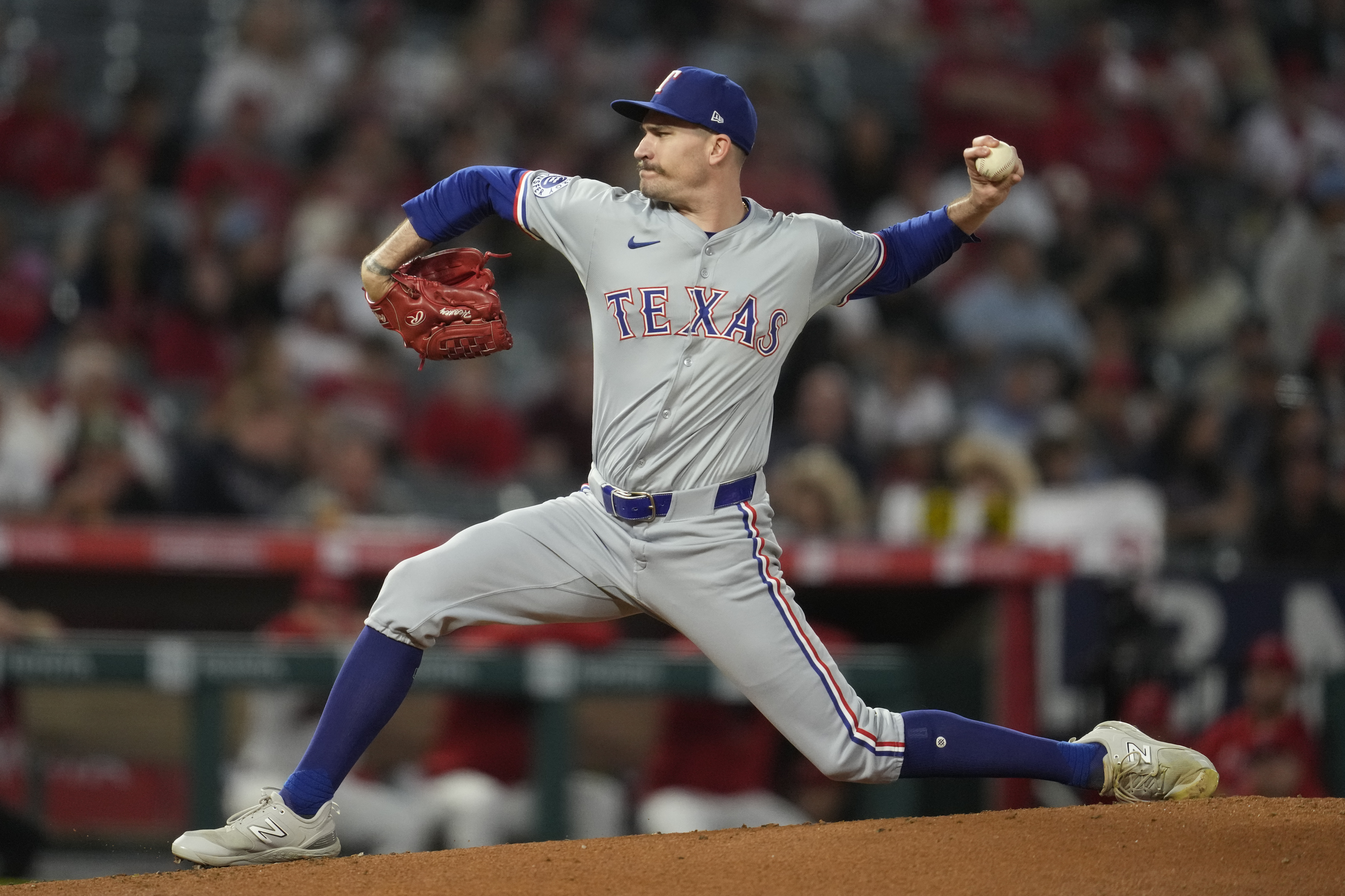 FILE - Texas Rangers starting pitcher Andrew Heaney throws during the first inning of a baseball game against the Los Angeles Angels in Anaheim, Calif., Sept. 28, 2024. 