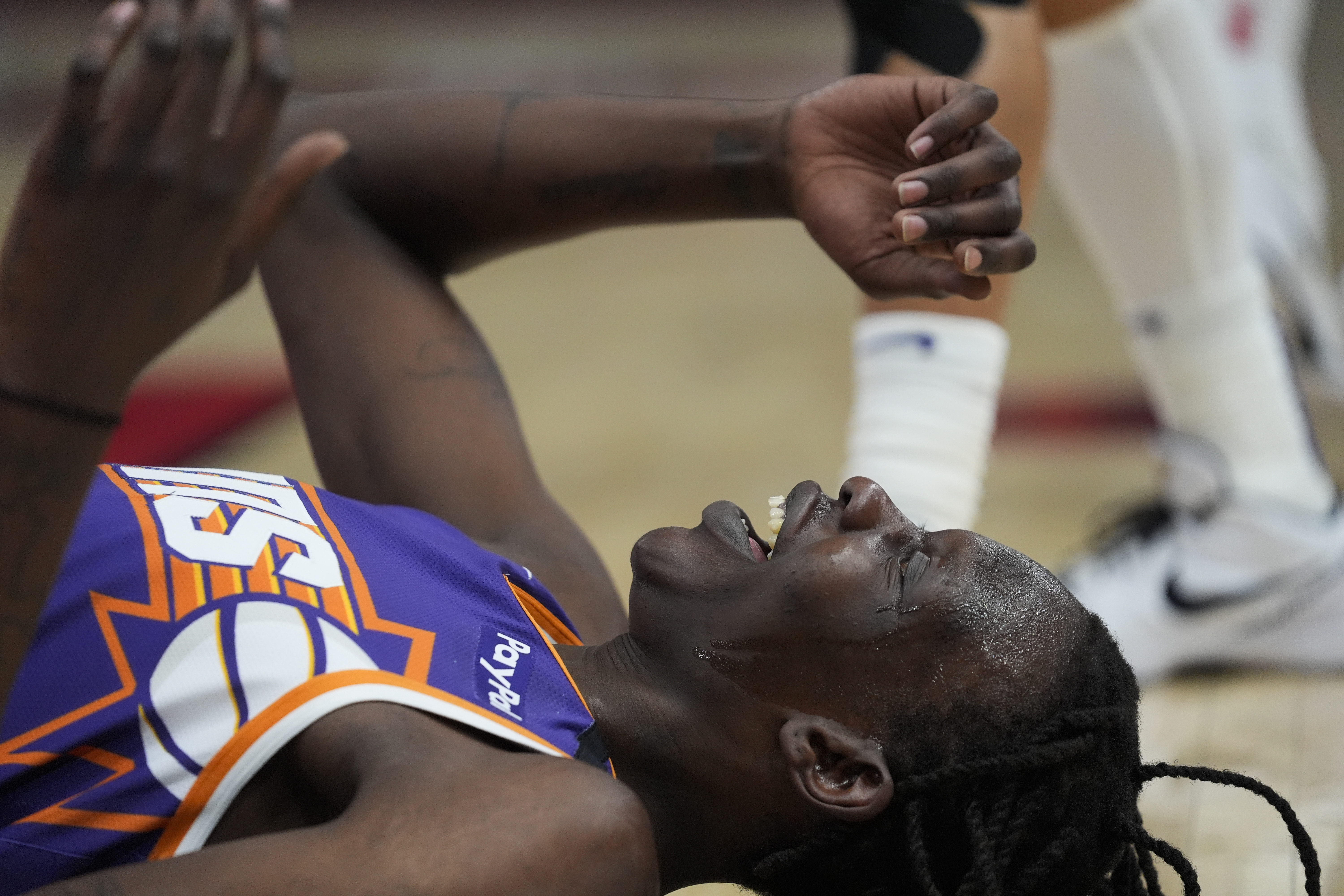 Phoenix Suns center Bol Bol (11) lays on the ground after blocking a shot from the Chicago Bulls during the first half of an NBA basketball game Saturday, Feb. 22, 2025, in Chicago. 