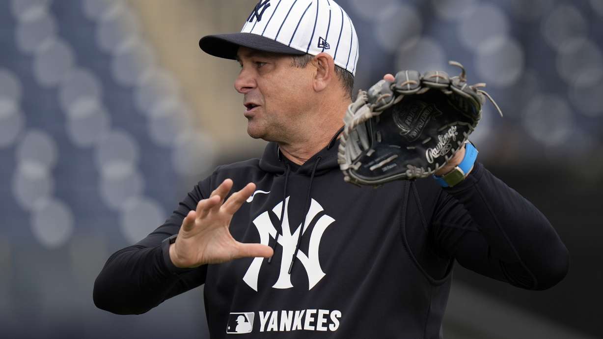 New York Yankees manager Aaron Boone demonstrates a play during a spring training baseball workout Thursday, Feb. 20, 2025, in Tampa, Fla.