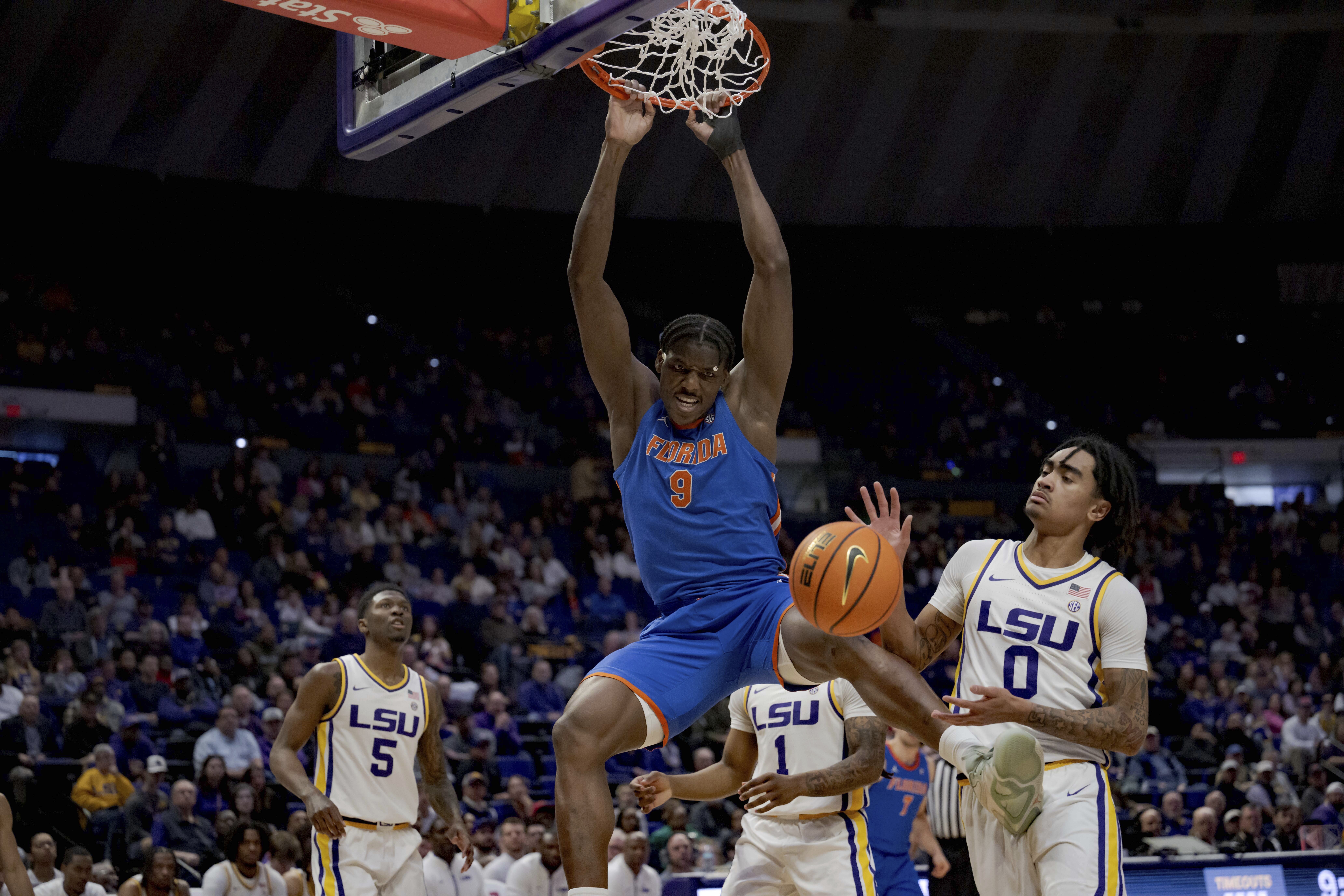 Florida center Rueben Chinyelu (9) dunks against LSU guard Vyctorius Miller (0) during the first half of an NCAA college basketball game in Baton Rouge, La., Saturday, Feb. 22, 2025. 